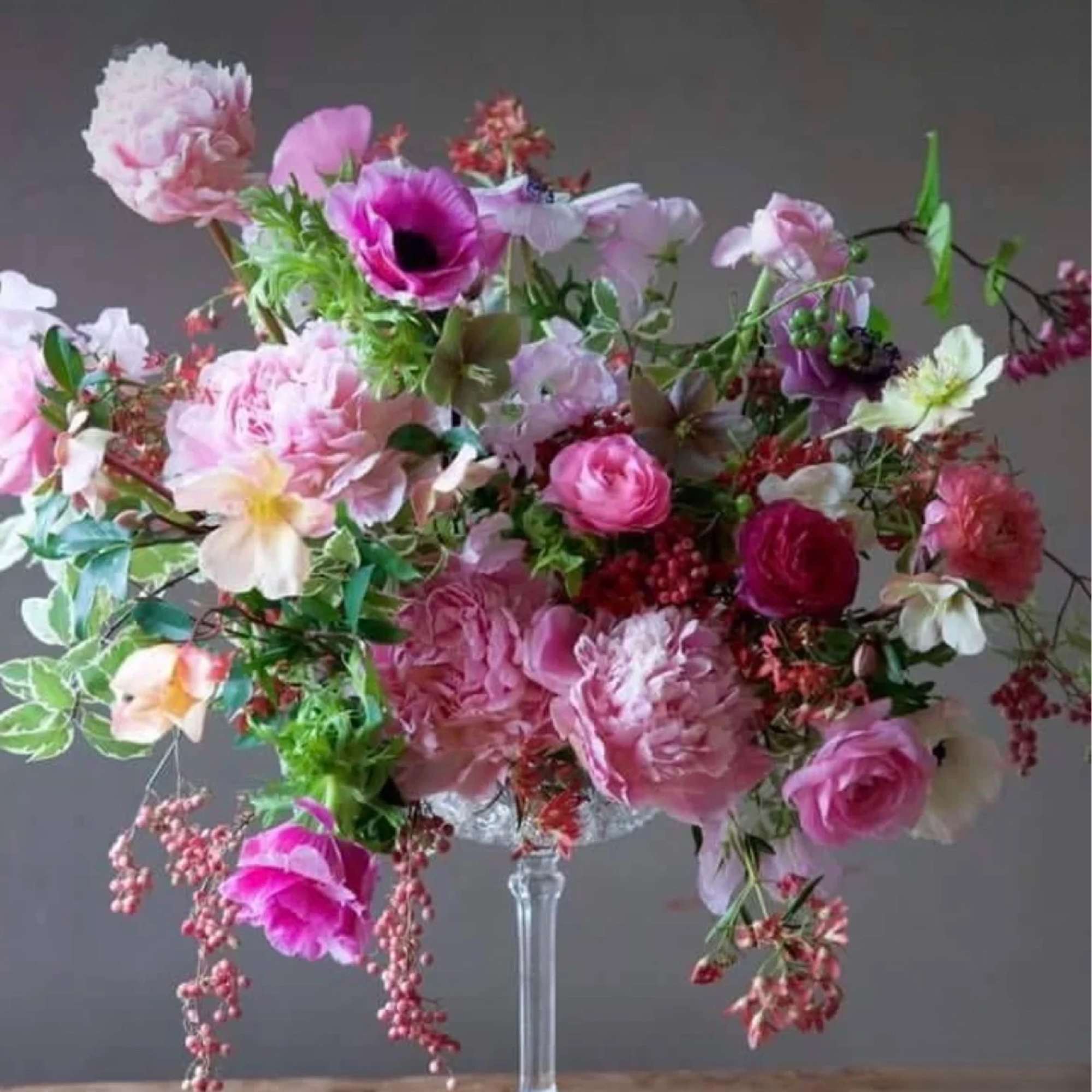 Large pink and white floral arrangement in a clear glass vase