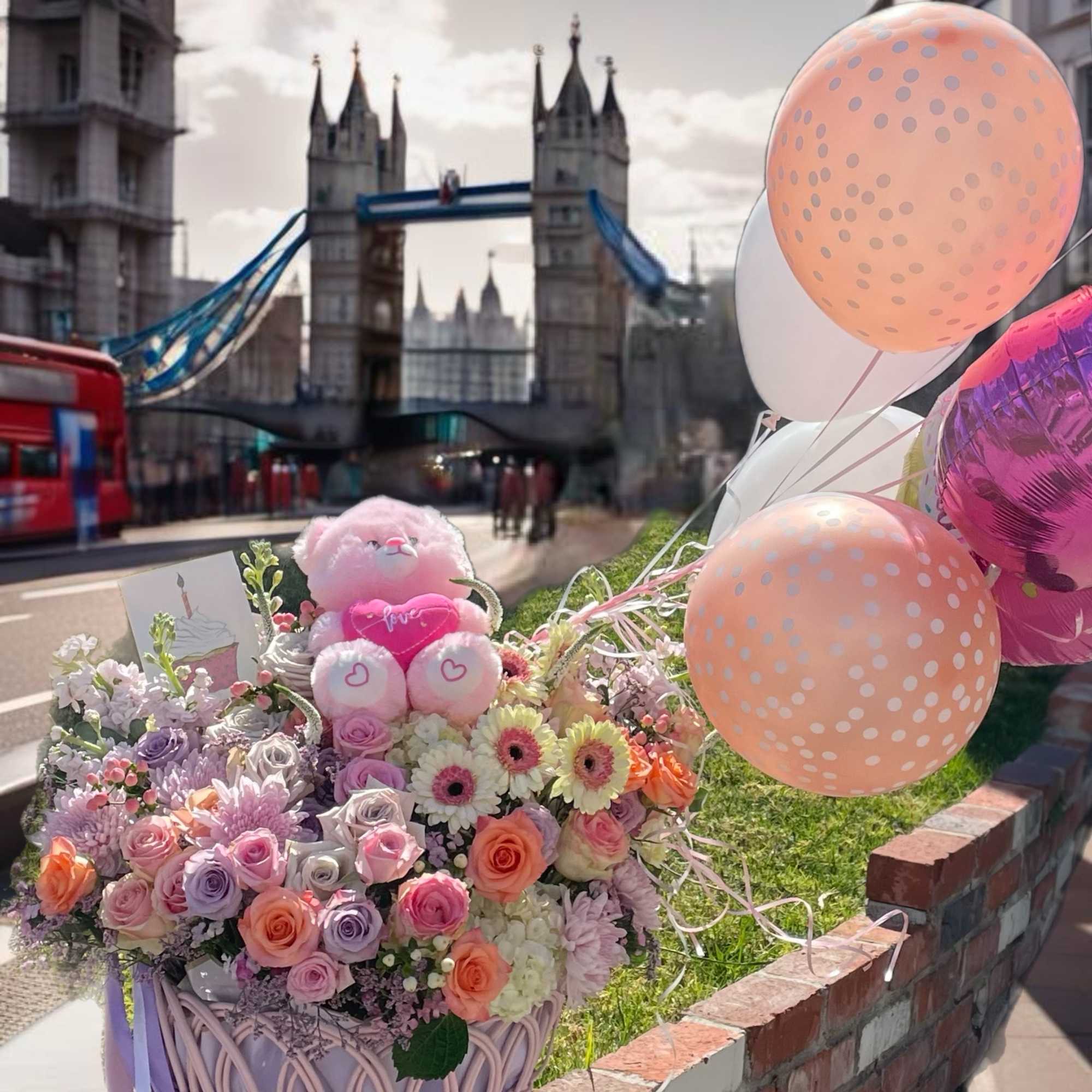 Pastel flower basket with a teddy bear and balloons