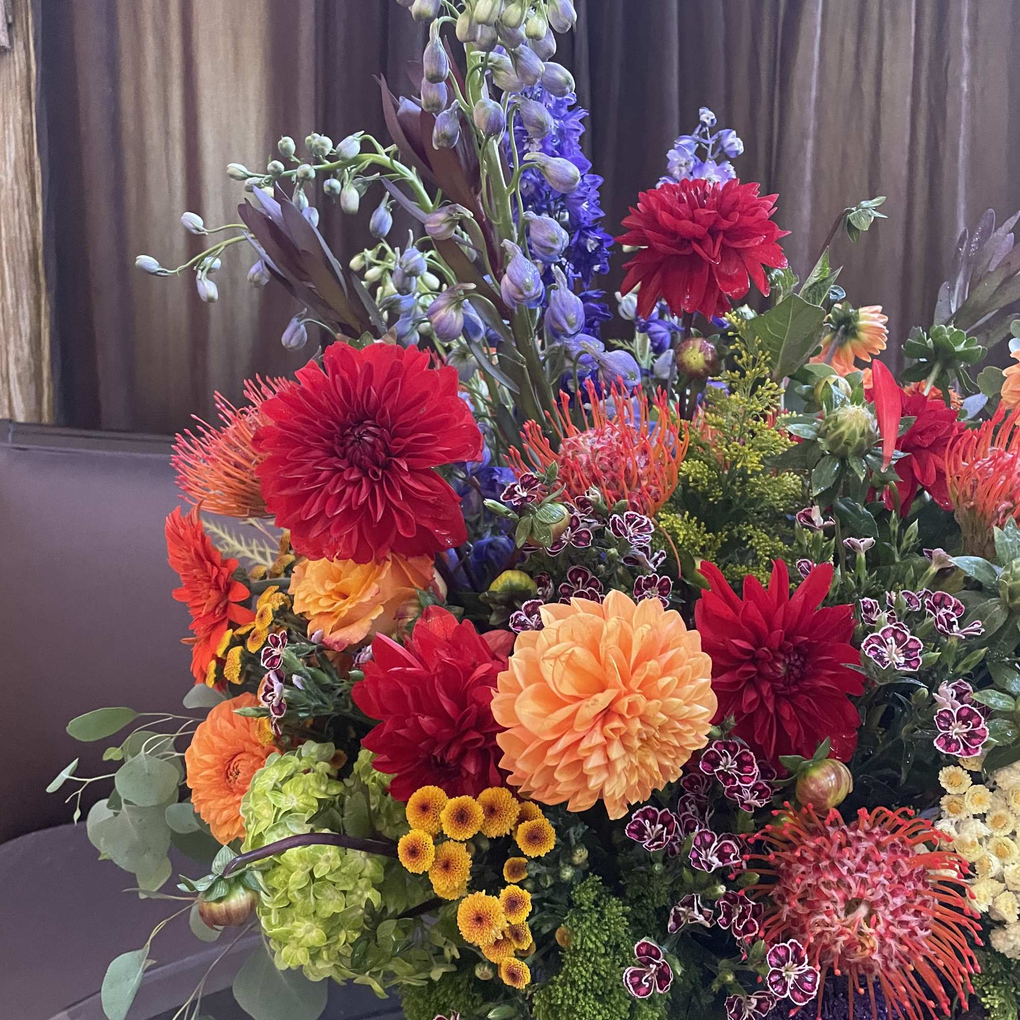 Large mixed bouquet with red, orange, purple, and yellow blooms