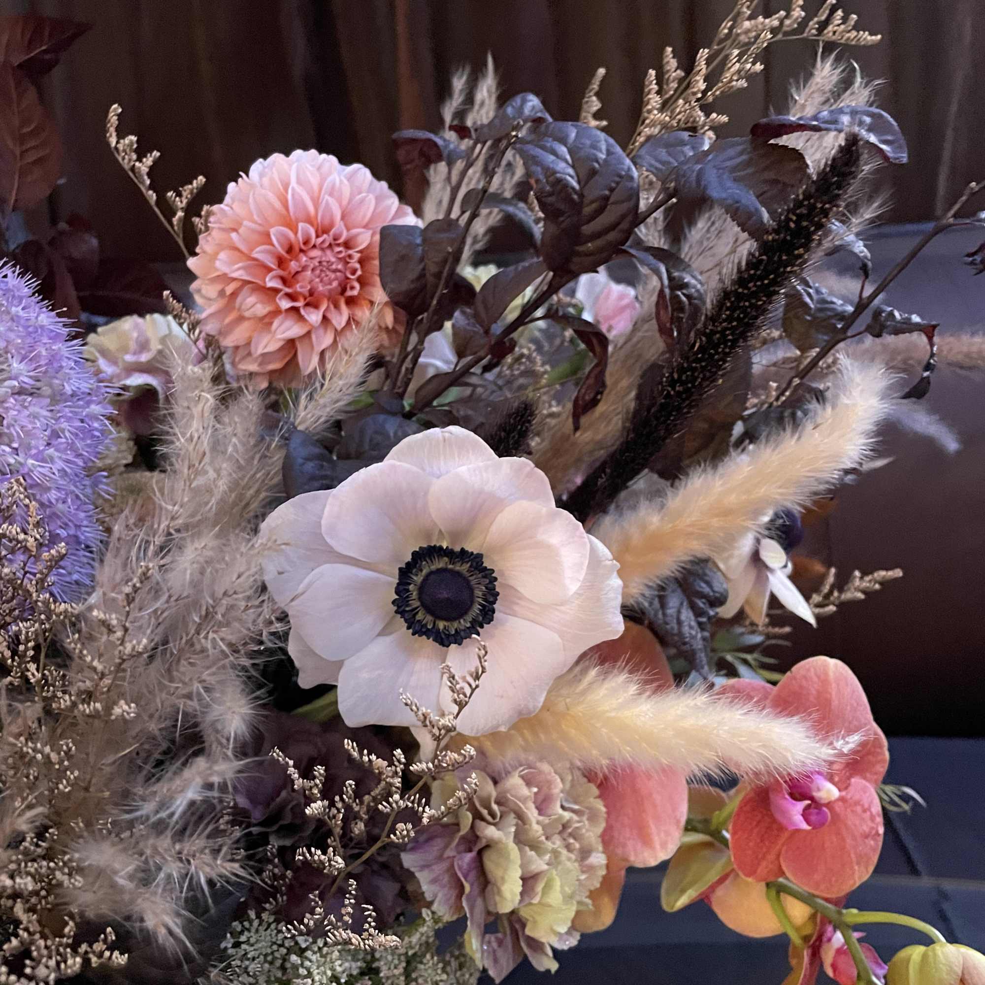 Bouquet with anemones, dahlias, and orchids in soft pastel tones