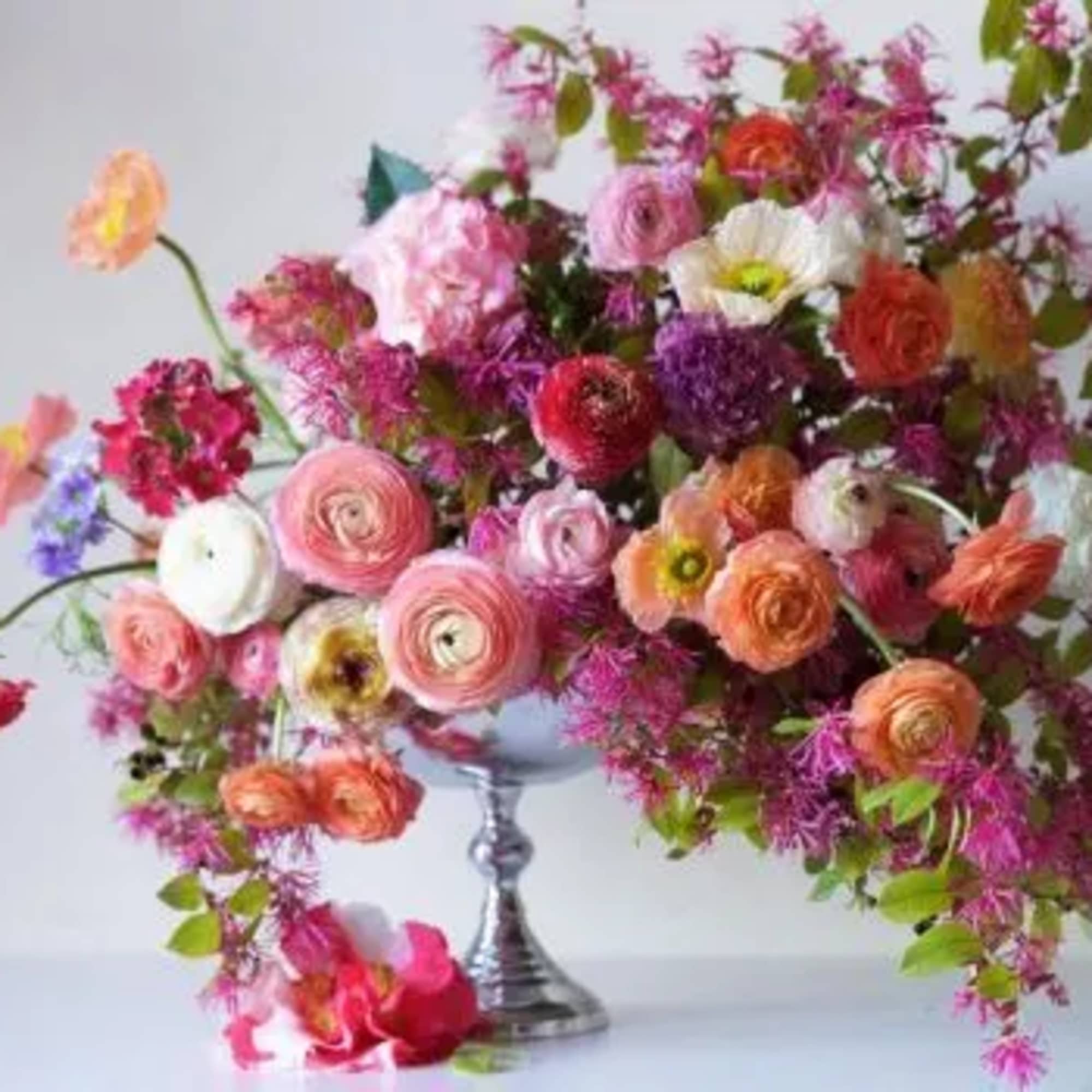 Colorful mixed bouquet in a silver pedestal vase