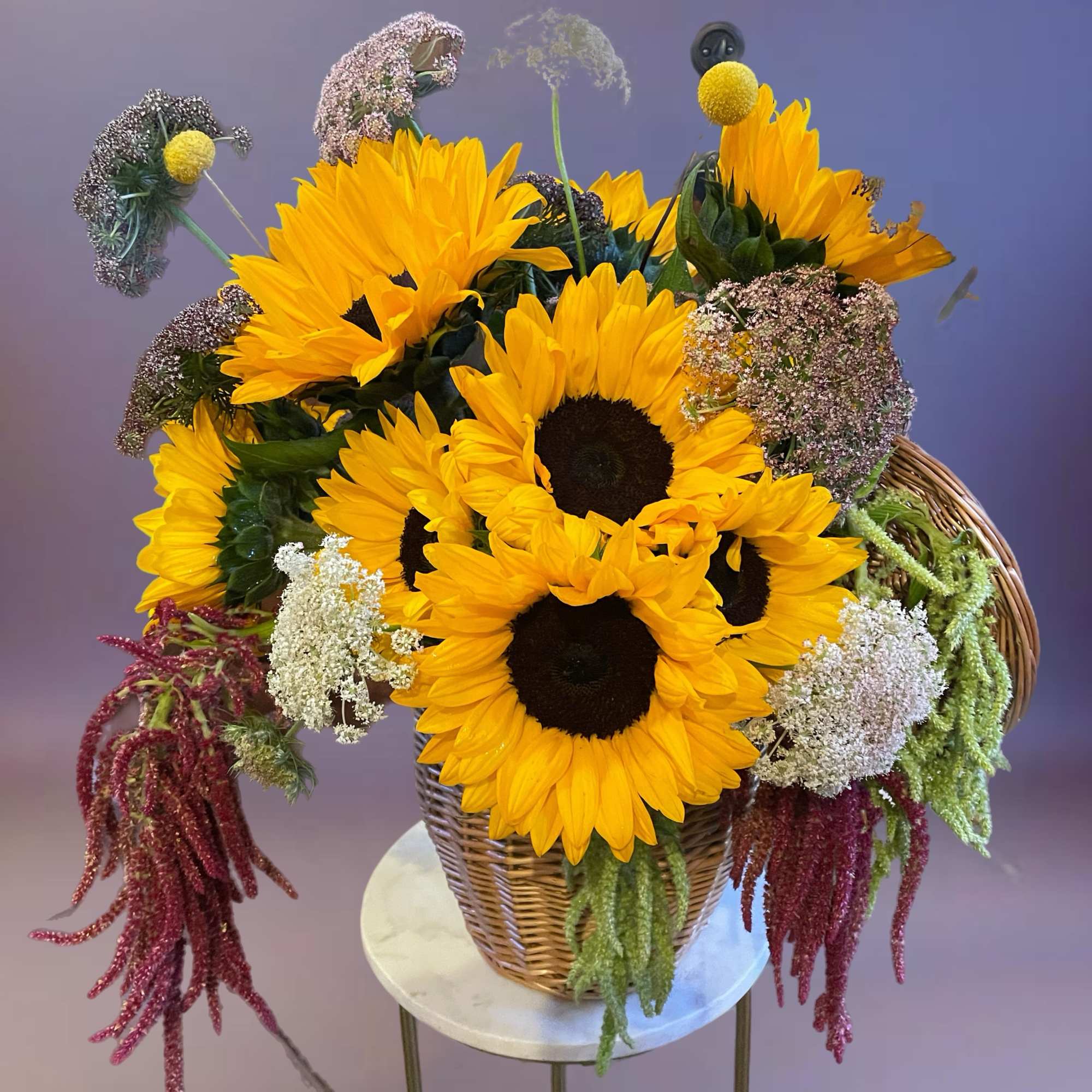 Basket arrangement of sunflowers with mixed filler flowers