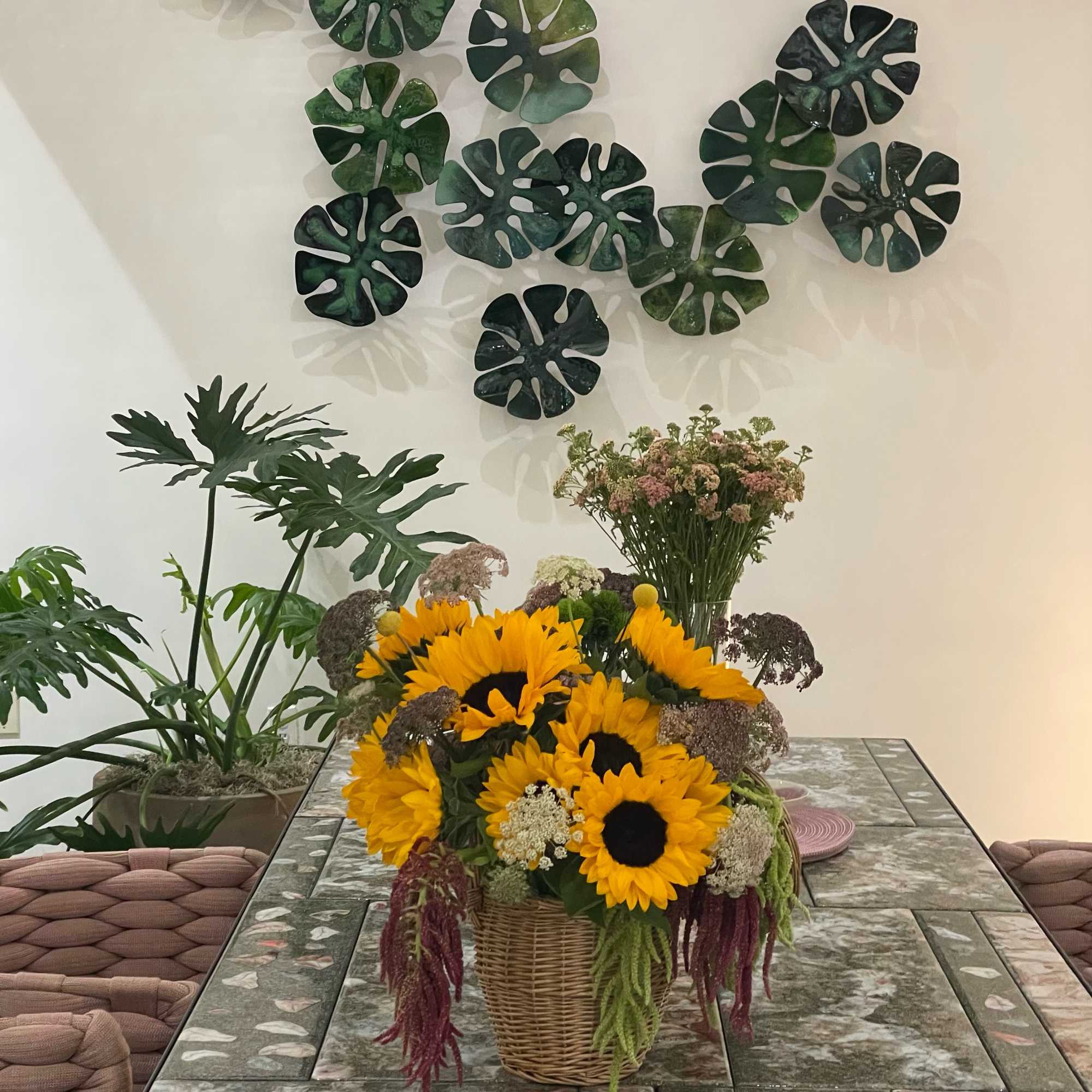 Sunflower arrangement in a wicker basket on a table