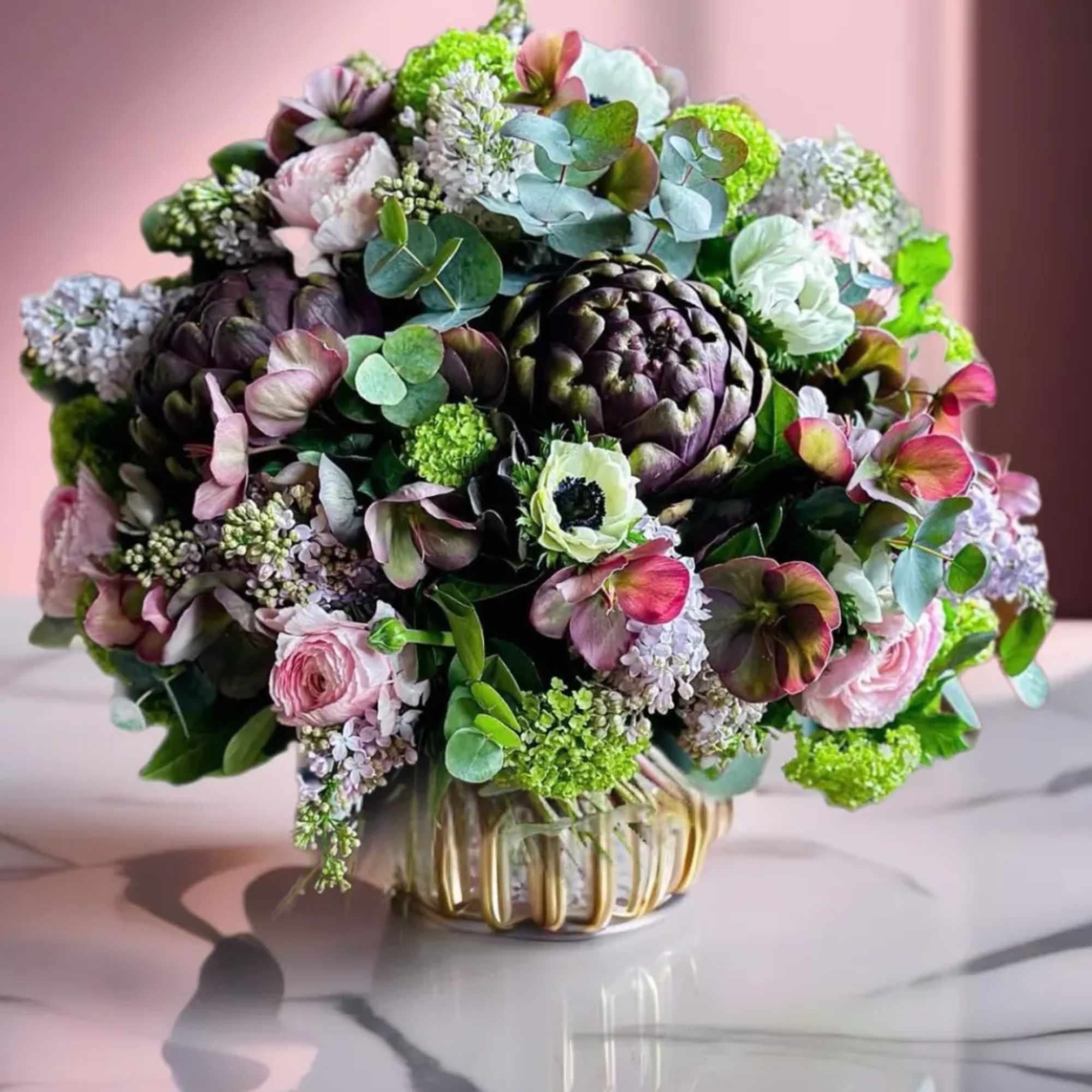 Bouquet of pink and green flowers in a glass vase