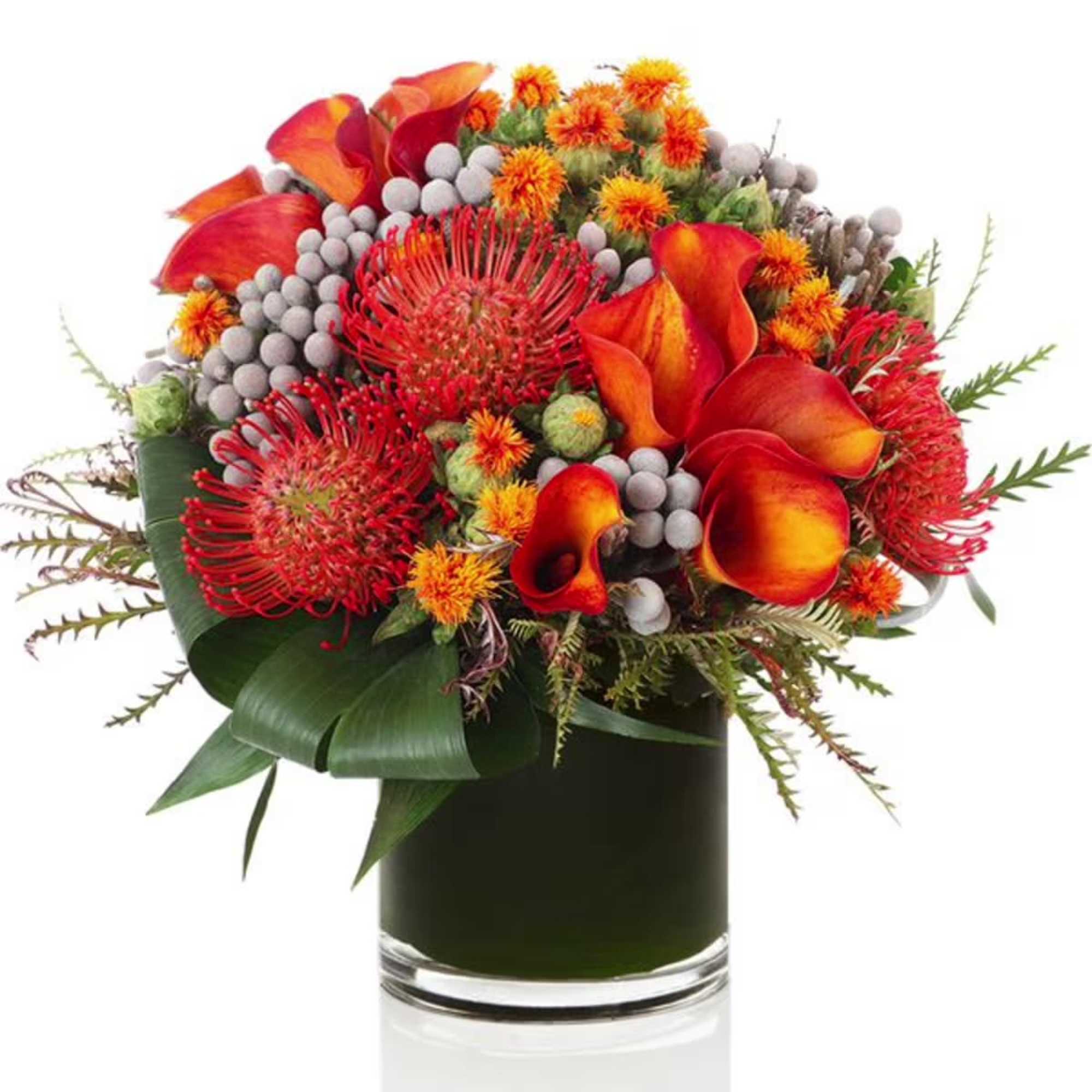 Orange and red floral arrangement in a glass vase