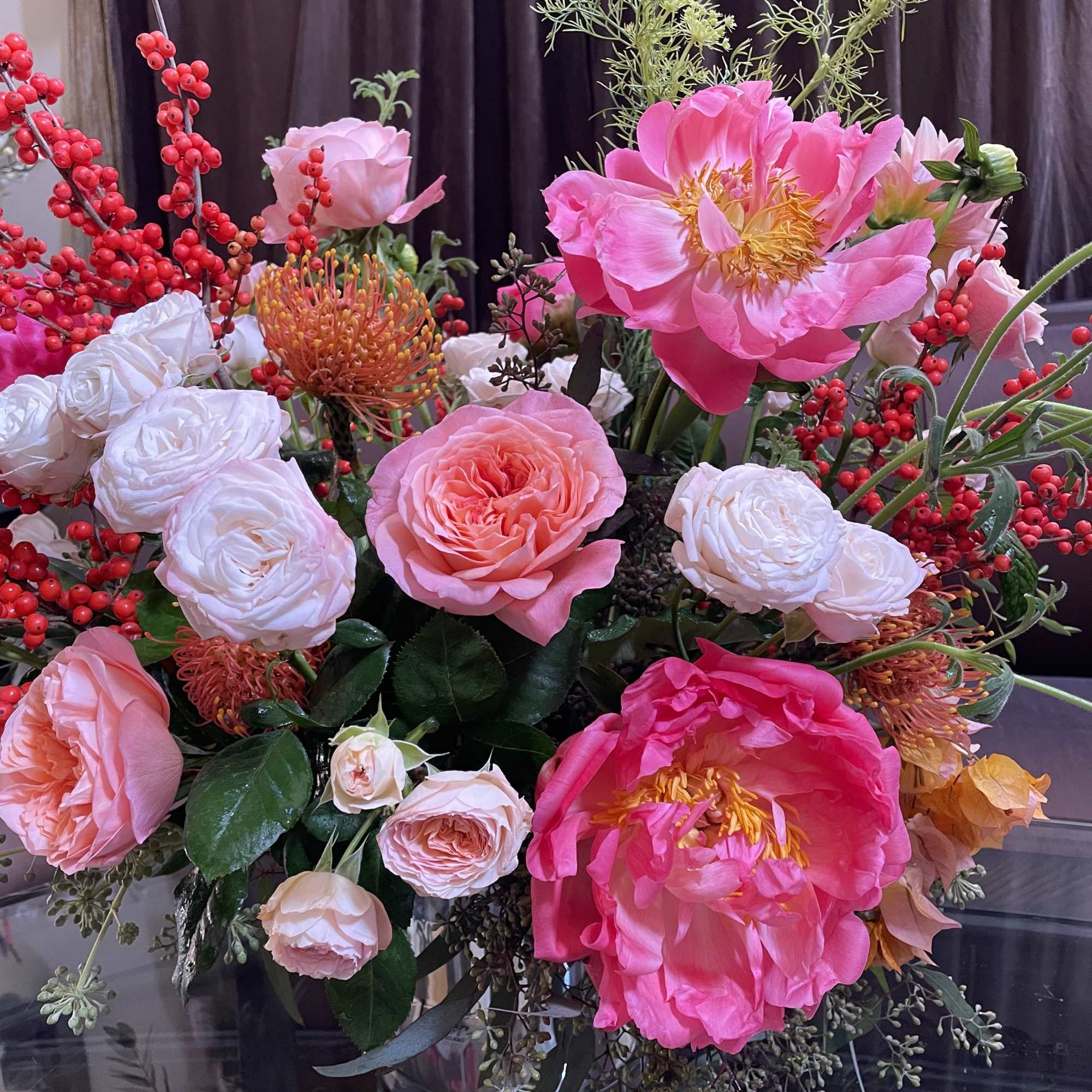 Mixed bouquet of pink and white flowers in a glass vase