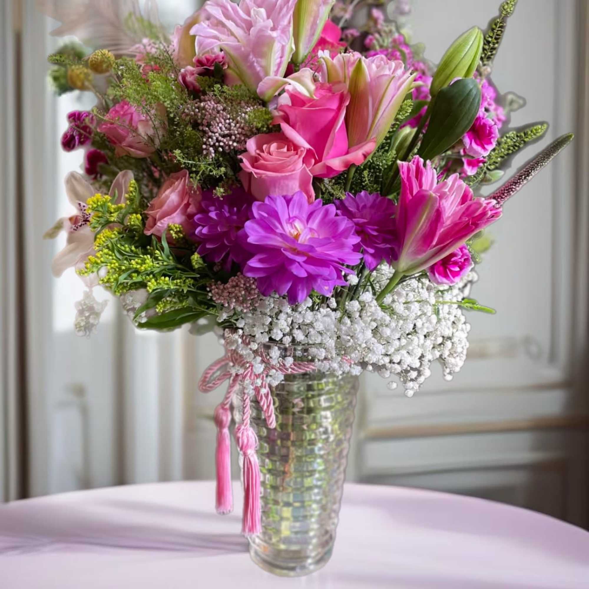 Pink and purple mixed bouquet in a clear glass vase