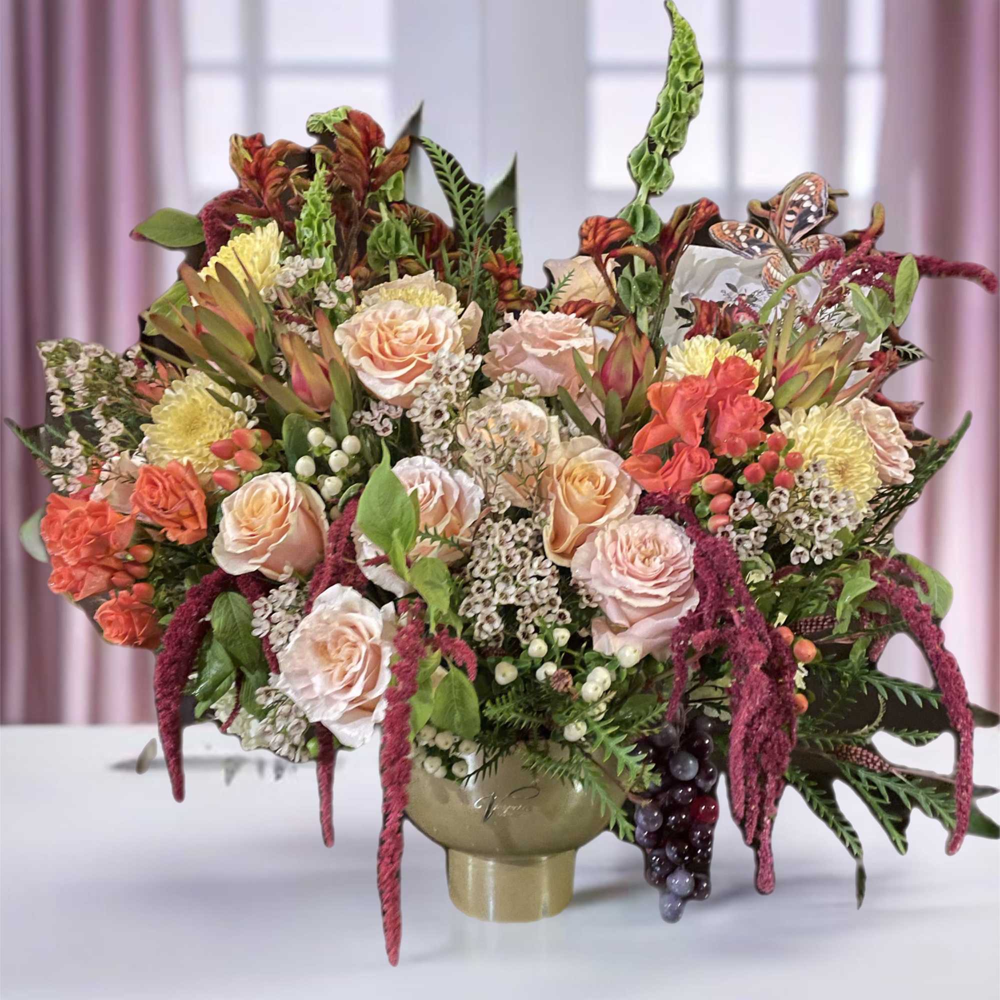Large bouquet of peach and pink roses in a vase