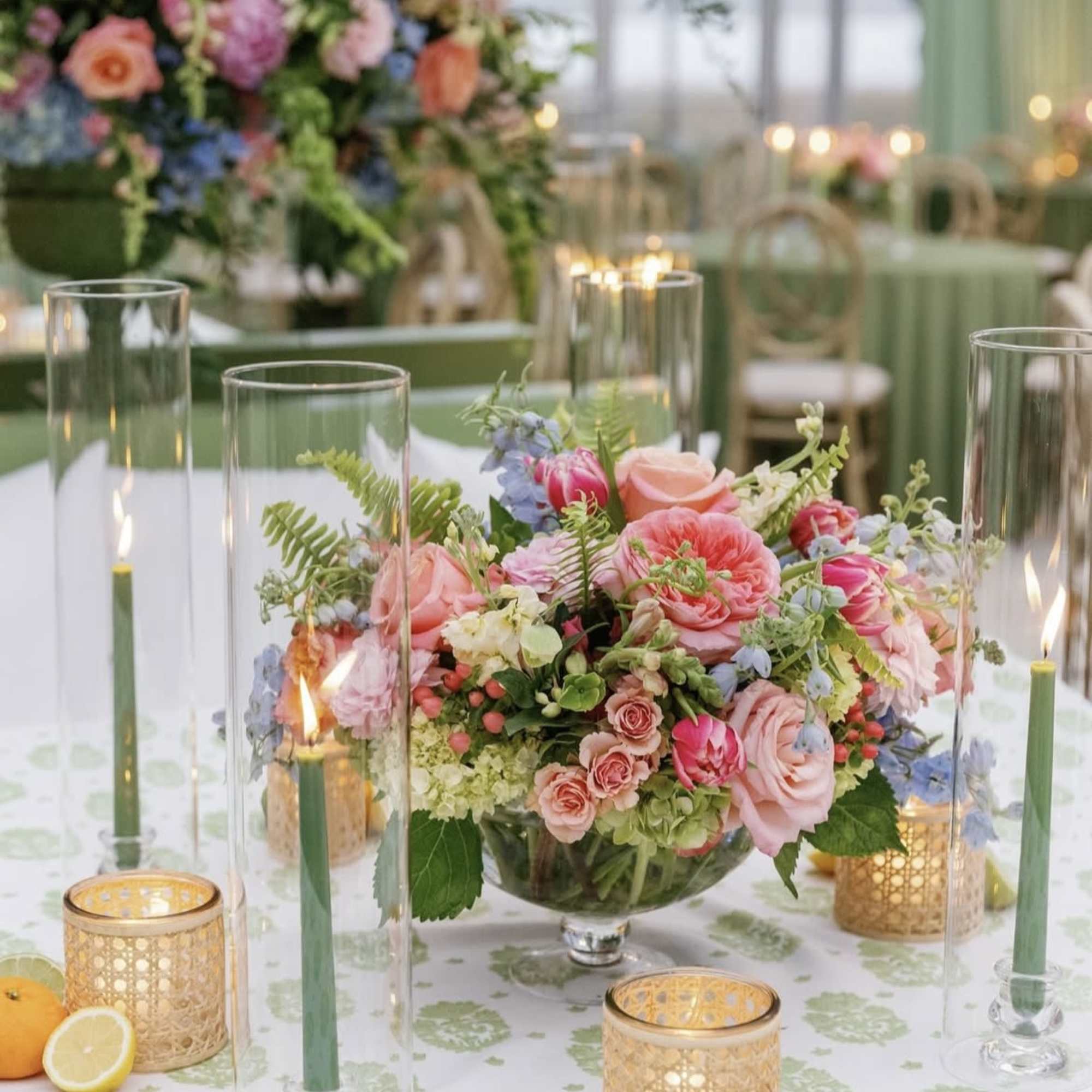 Low floral centerpiece with pink and peach roses in a glass bowl