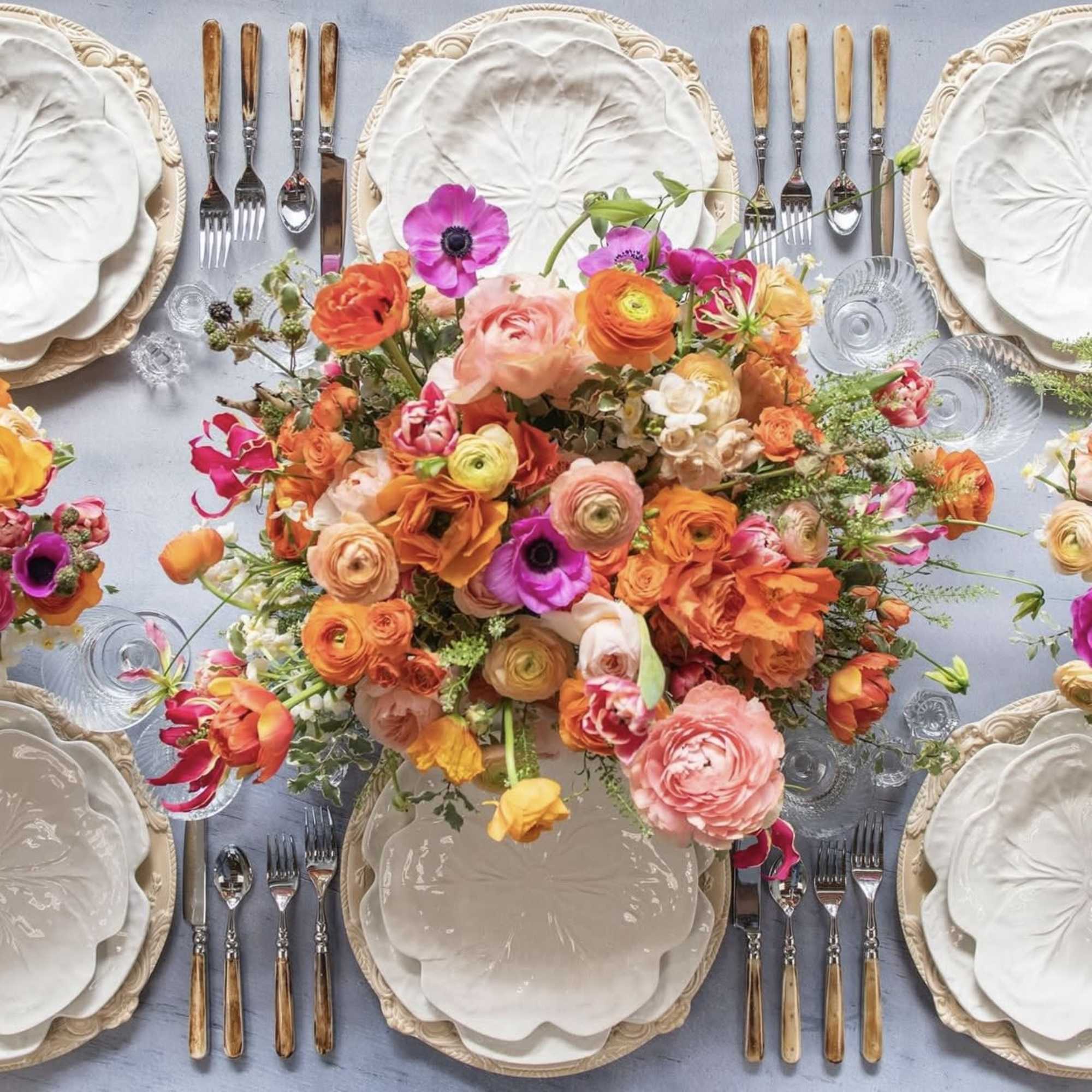 Bright mixed floral centerpiece on a set dining table