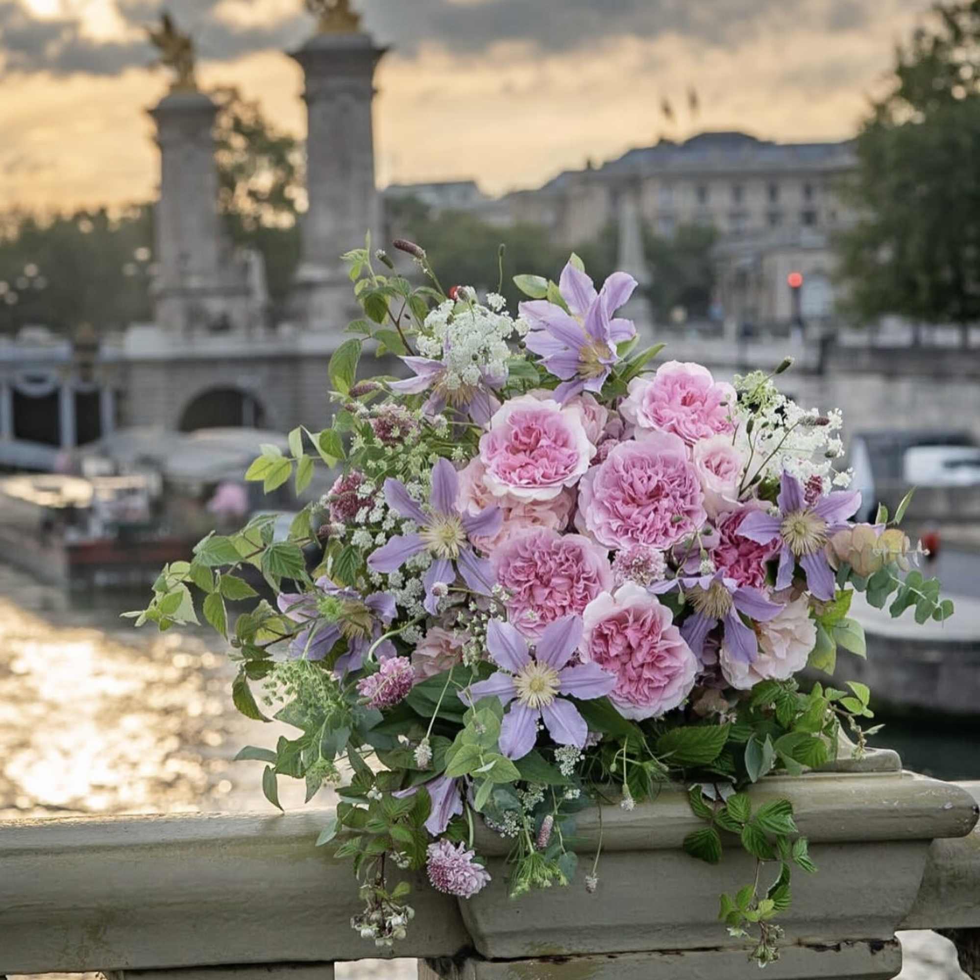Pink and lavender bouquet arranged on a stone railing