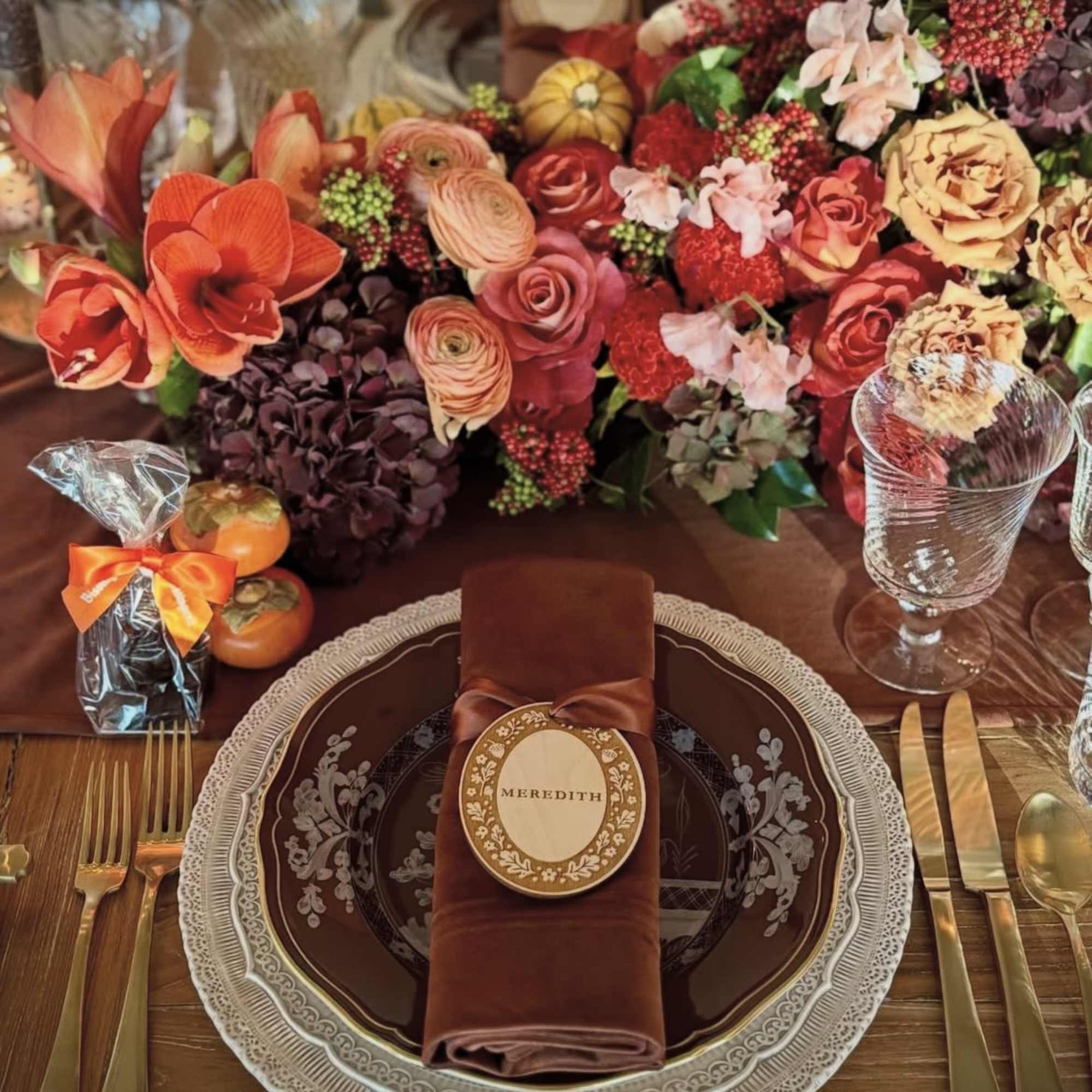 Autumn table setting with a large floral centerpiece and place settings