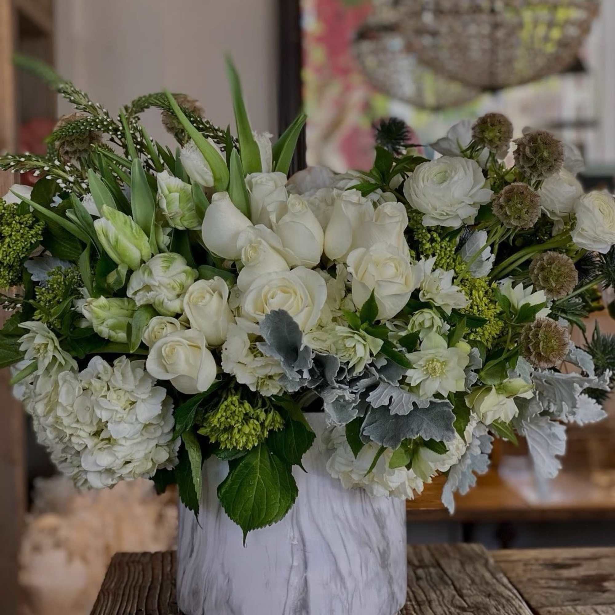White floral arrangement in a marble-patterned vase