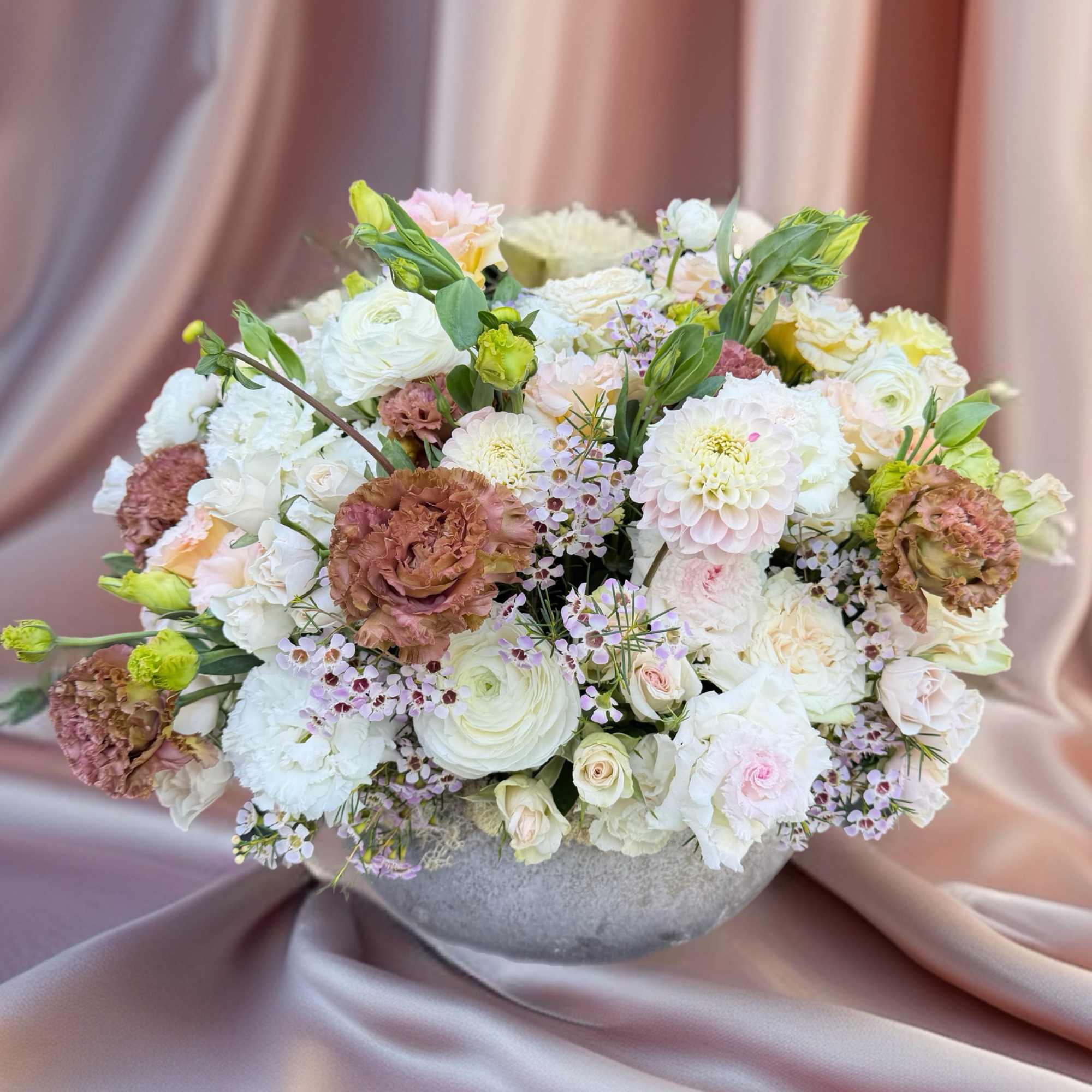 Large pastel bouquet in a gray bowl vase
