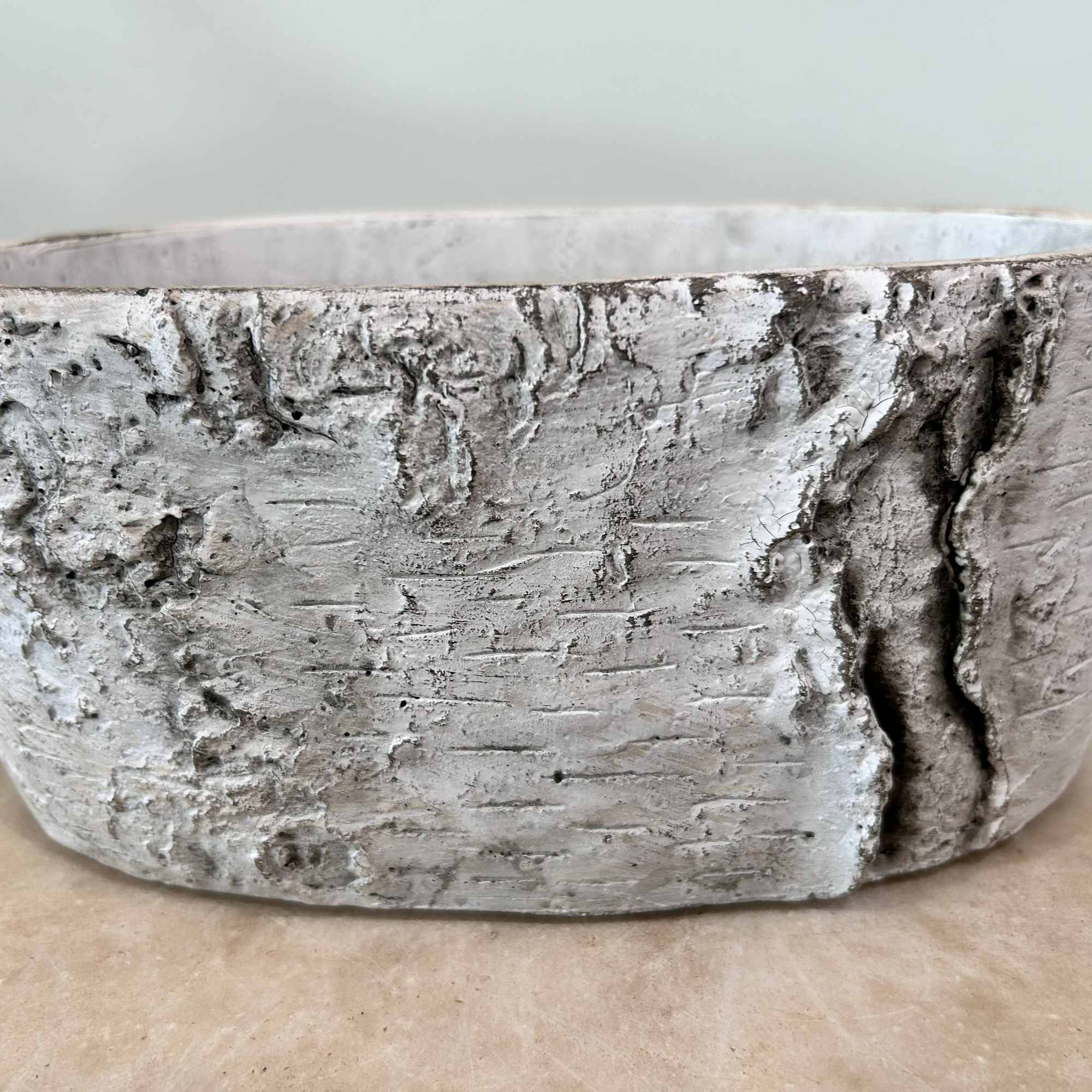 A ceramic basket is used as the base of this arrangement. The