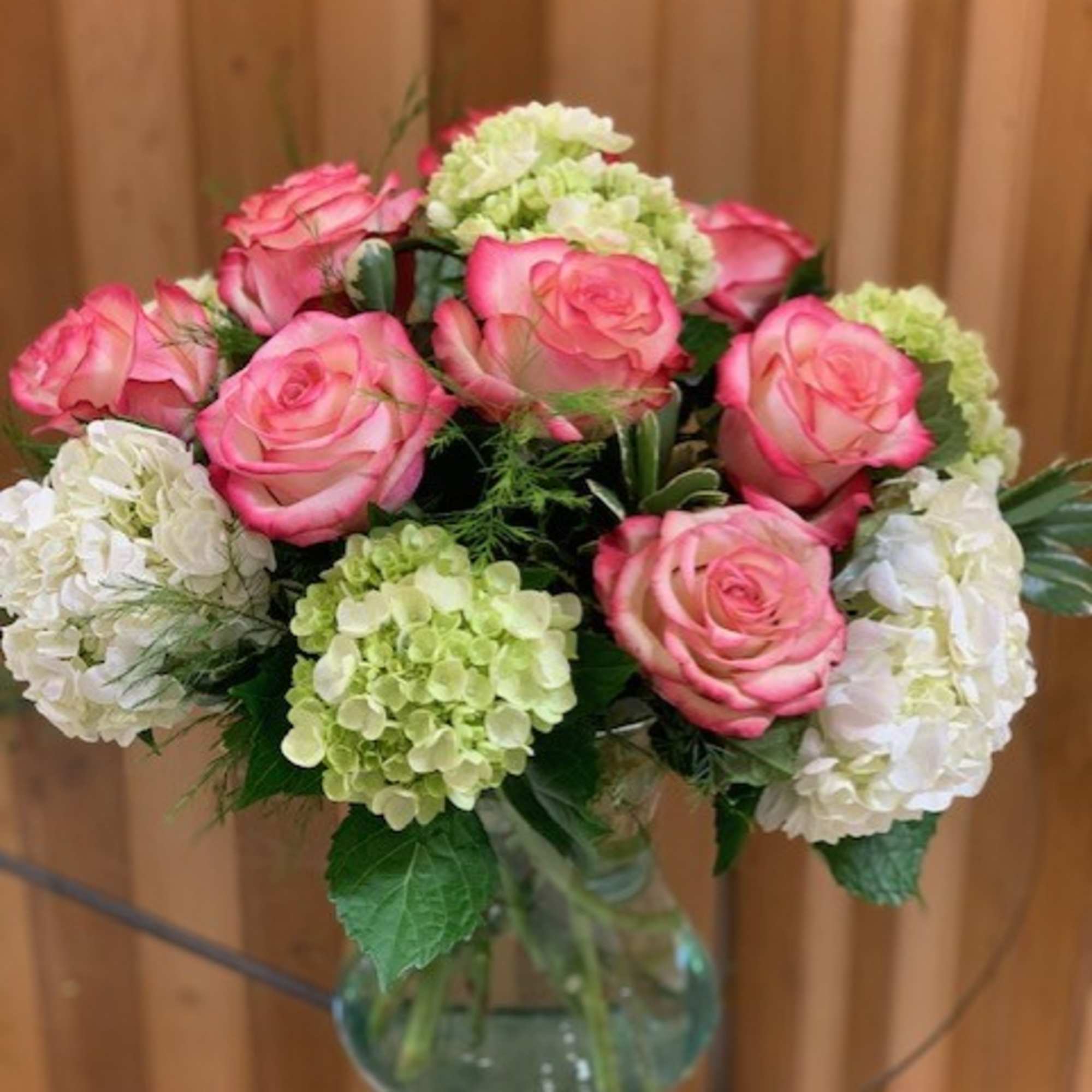 Pink roses and hydrangeas in a glass vase