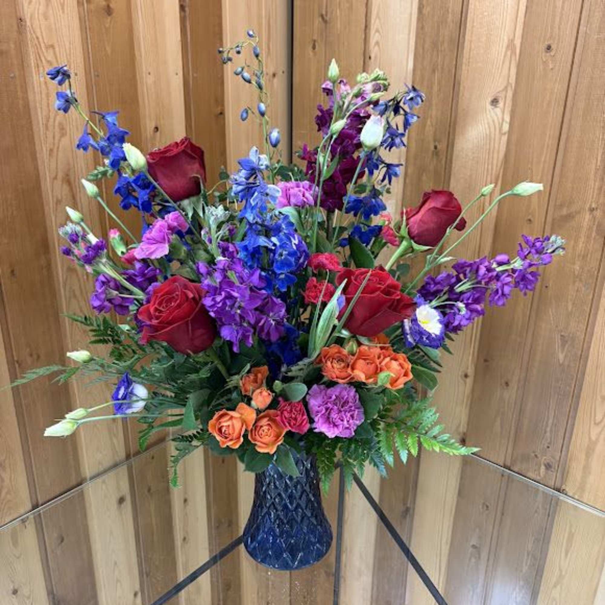 A tall, garden-style bouquet bursting with jewel-toned cheer-Joyful Noise is a flower