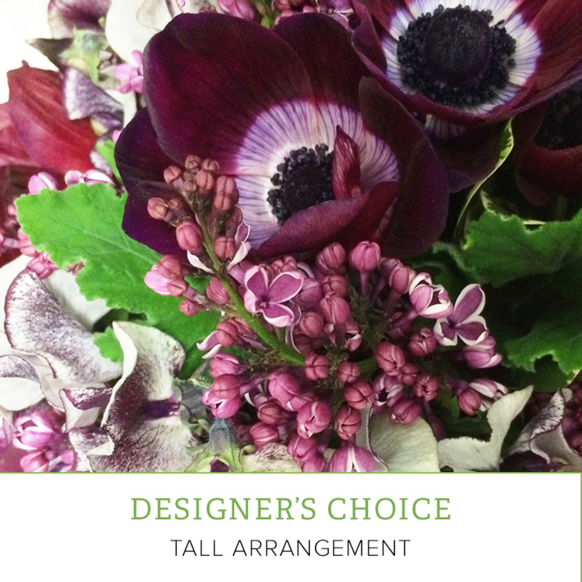 Purple and white anemones with pink blossoms in a floral arrangement