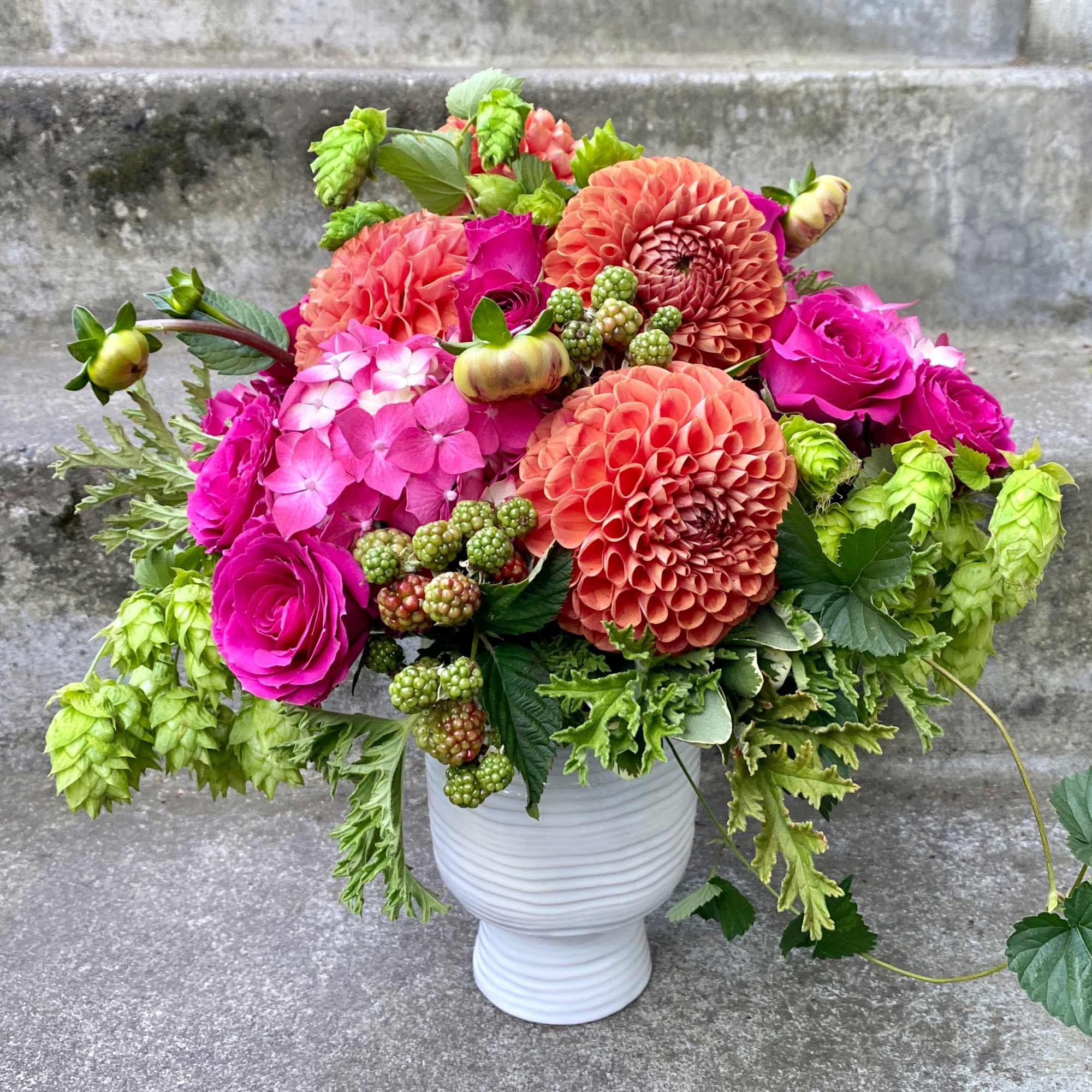 A Designer's Choice mixed floral arrangement featuring summer flowers such as dahlias, photo 3 of 9