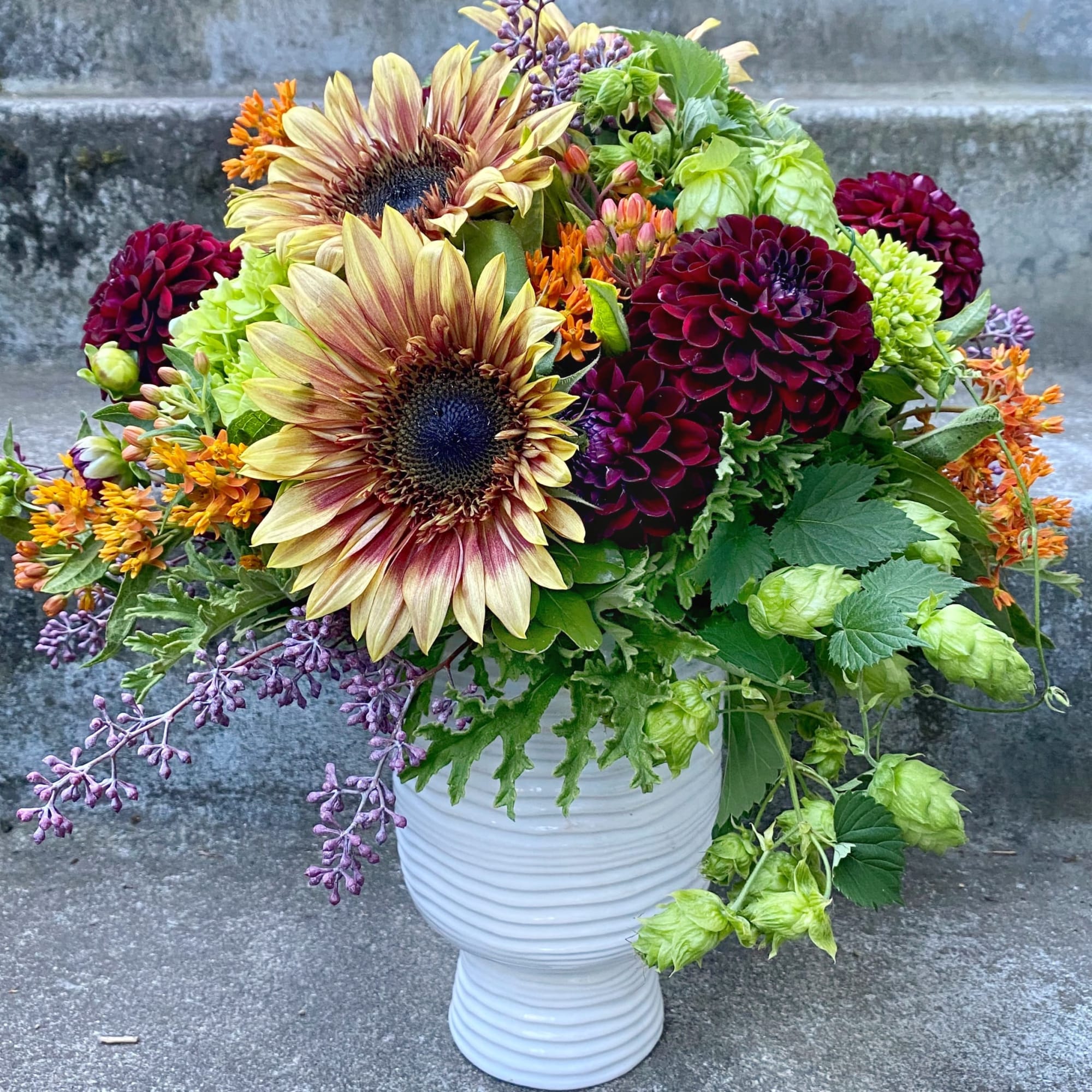 A Designer's Choice mixed floral arrangement featuring summer flowers such as dahlias, photo 7 of 7