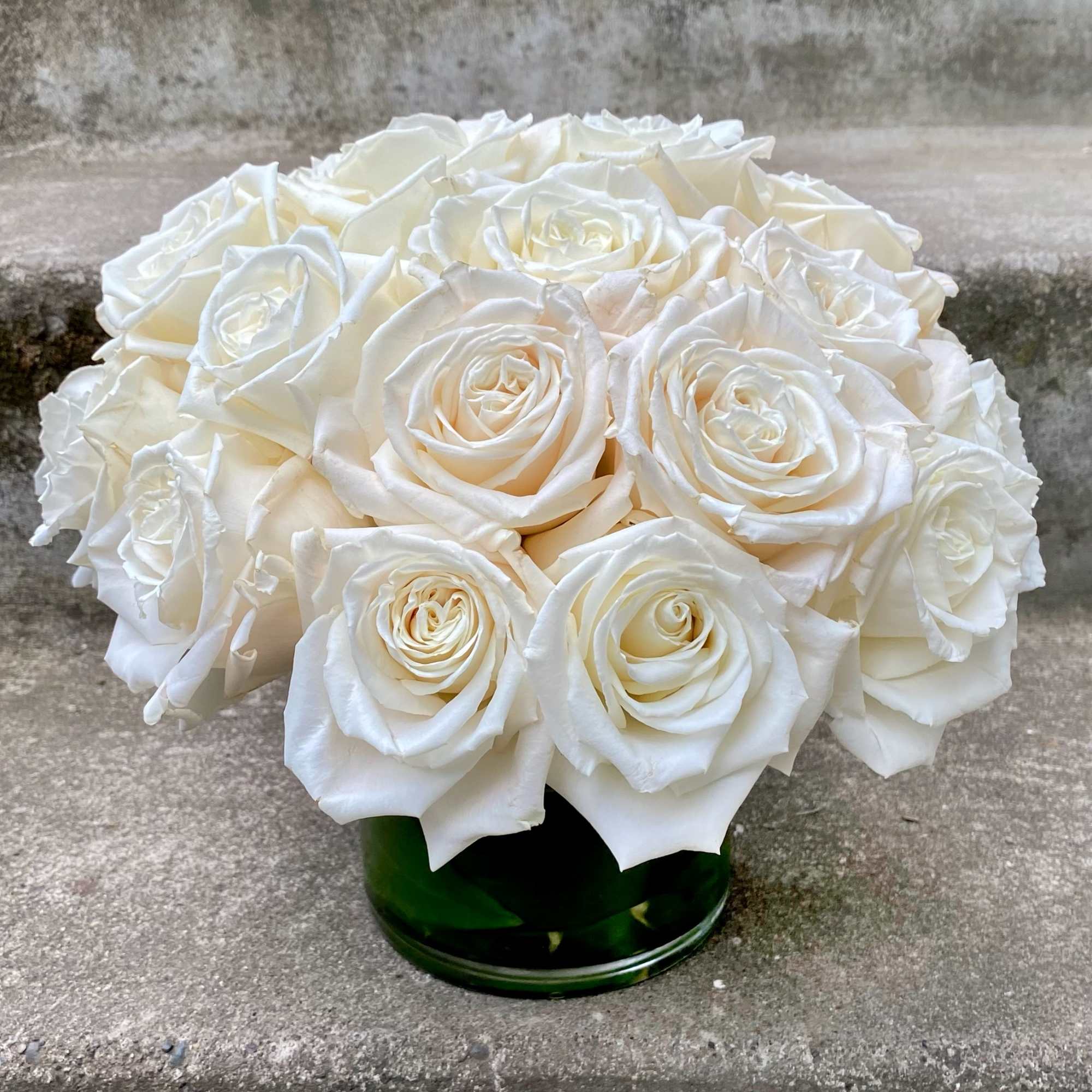 Classic, simple, perfect. One dozen premium white roses arranged without filler or