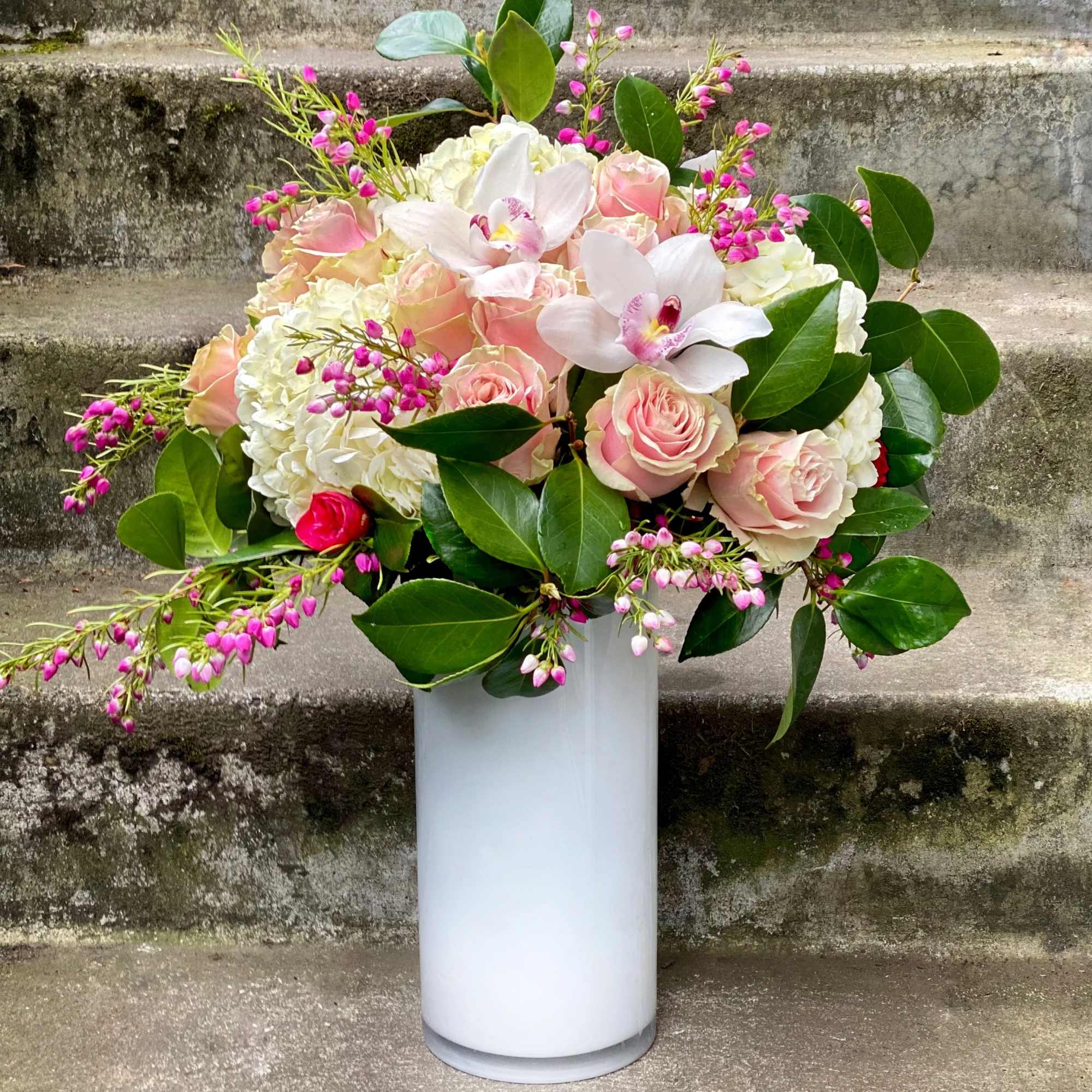 Pink and white floral arrangement in a white vase