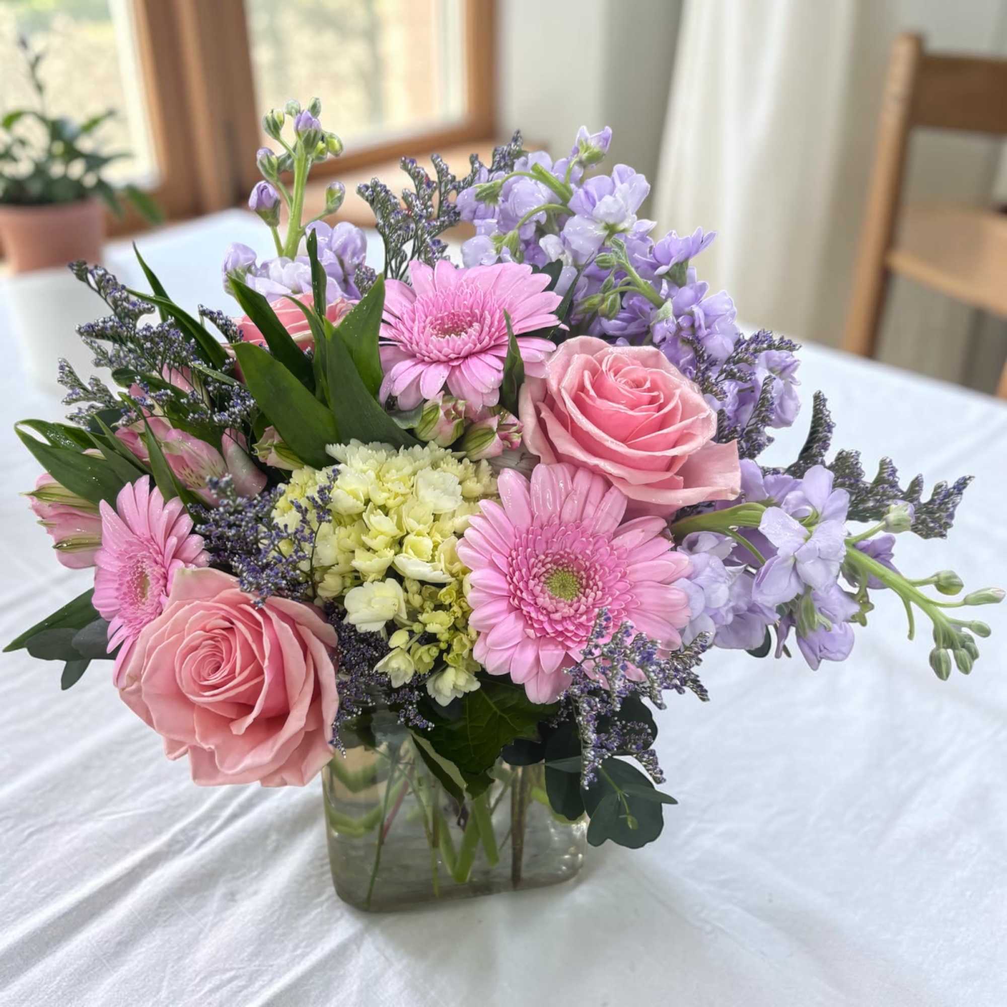 Spring Sorbet Cube is a soft pastel arrangement of pink roses, mini