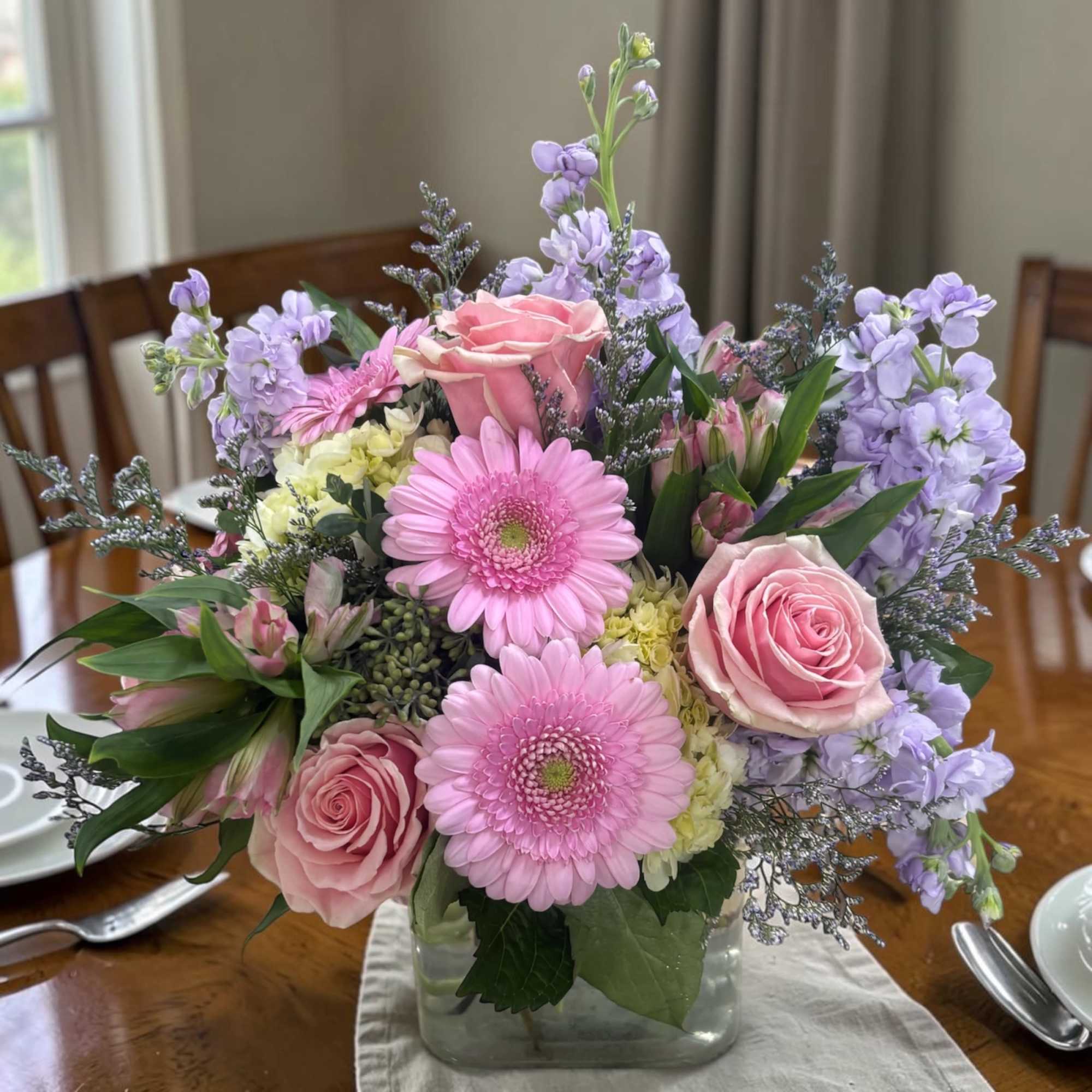 Spring Sorbet Cube is a soft pastel arrangement of pink roses, mini
