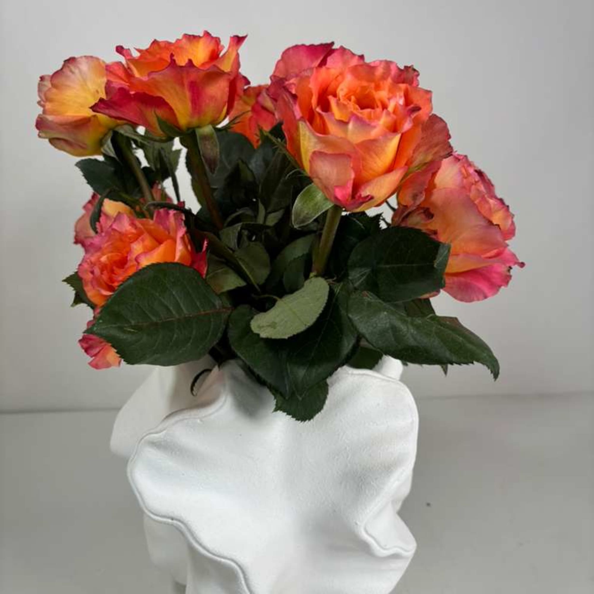 Bouquet of orange and pink roses in a white vase, photo 4 of 4