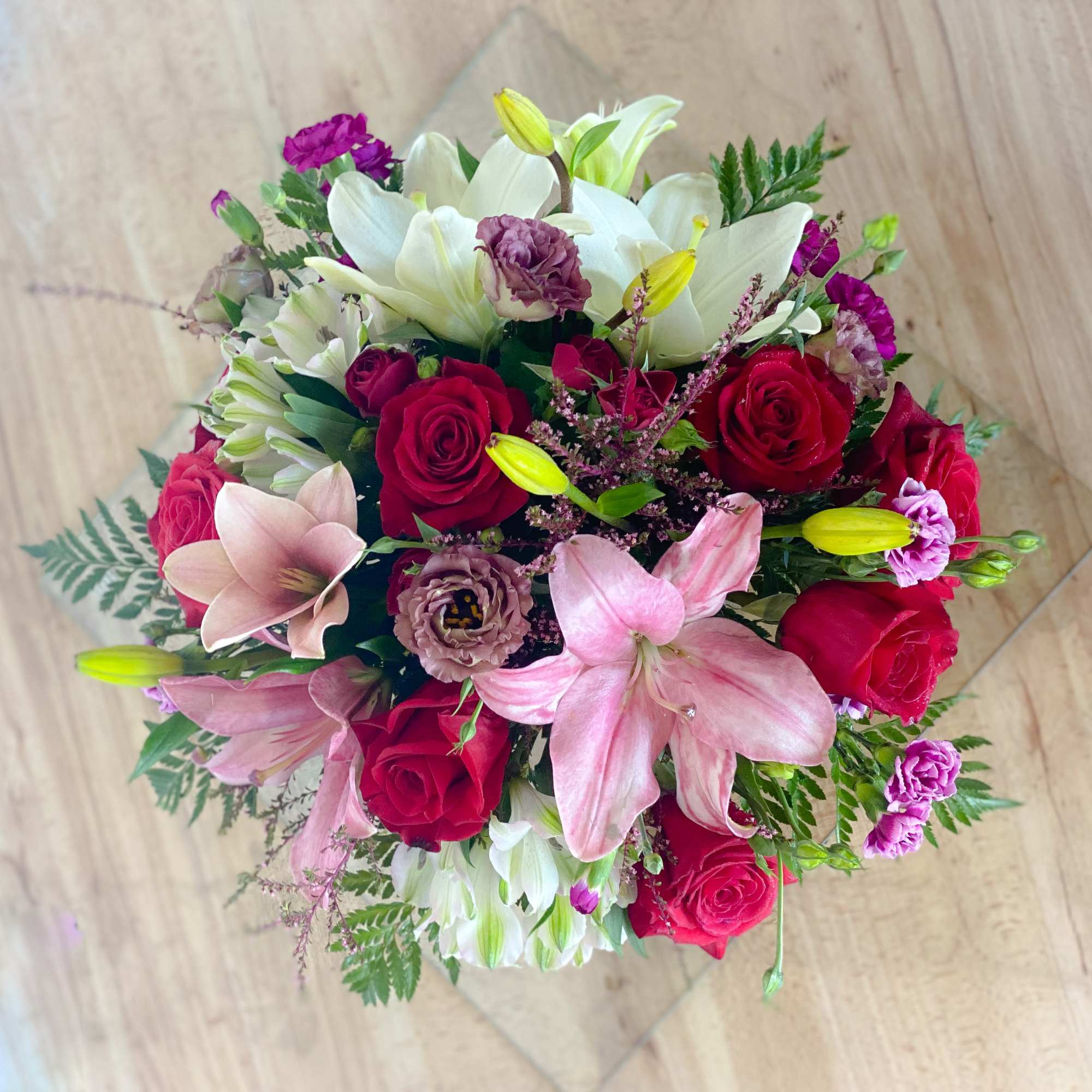 Bouquet of pink and red roses with white lilies and pink lilies