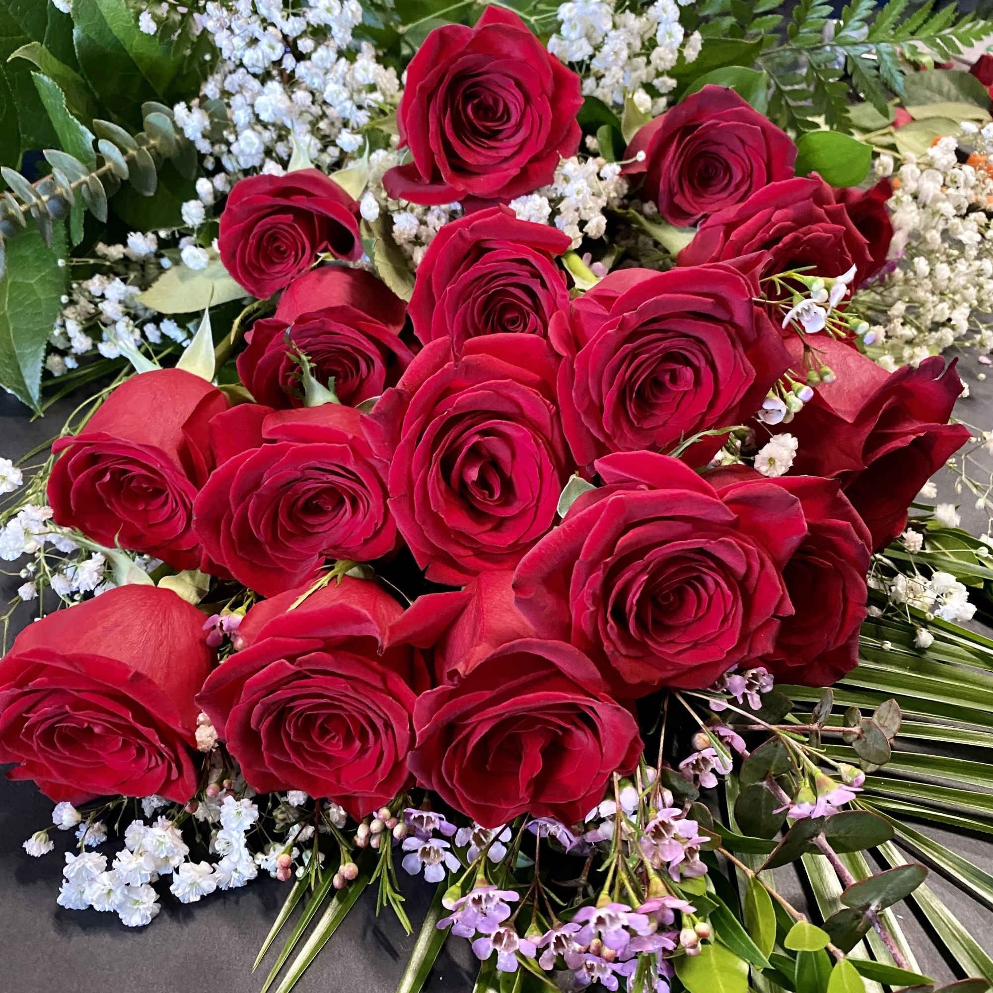Bouquet of red roses with white baby's breath and greenery