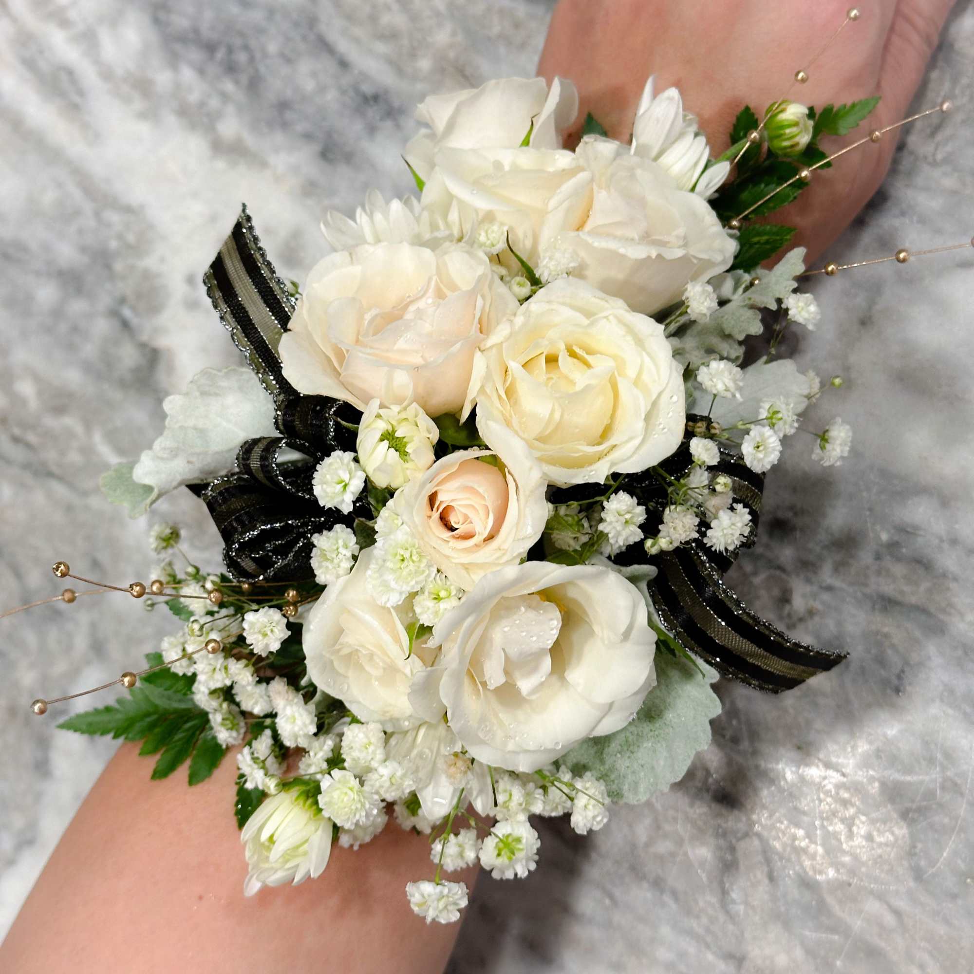 White rose wrist corsage with baby's breath and black ribbon