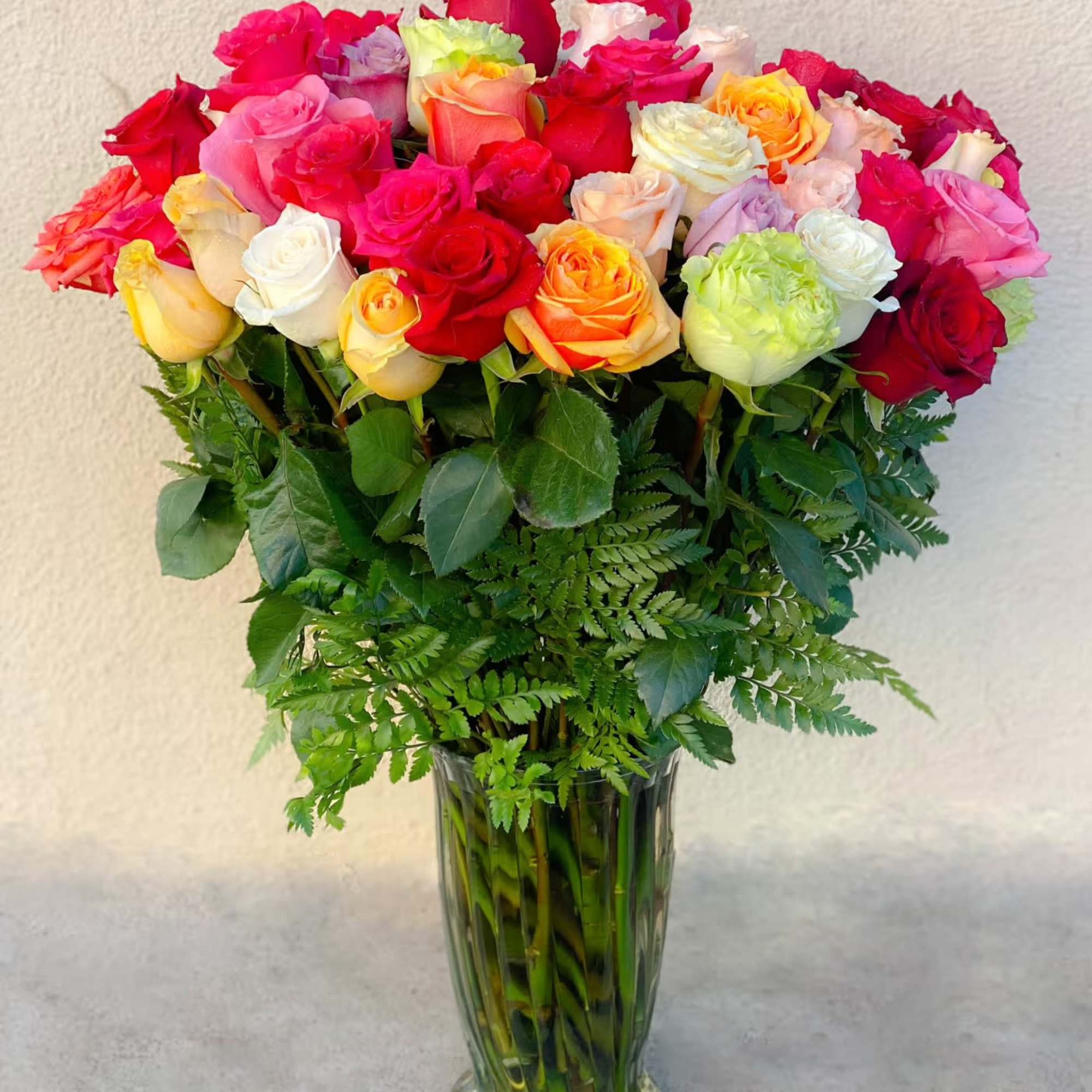 Send an explosion of color with this 24 extra long-stemmed rose arrangement
