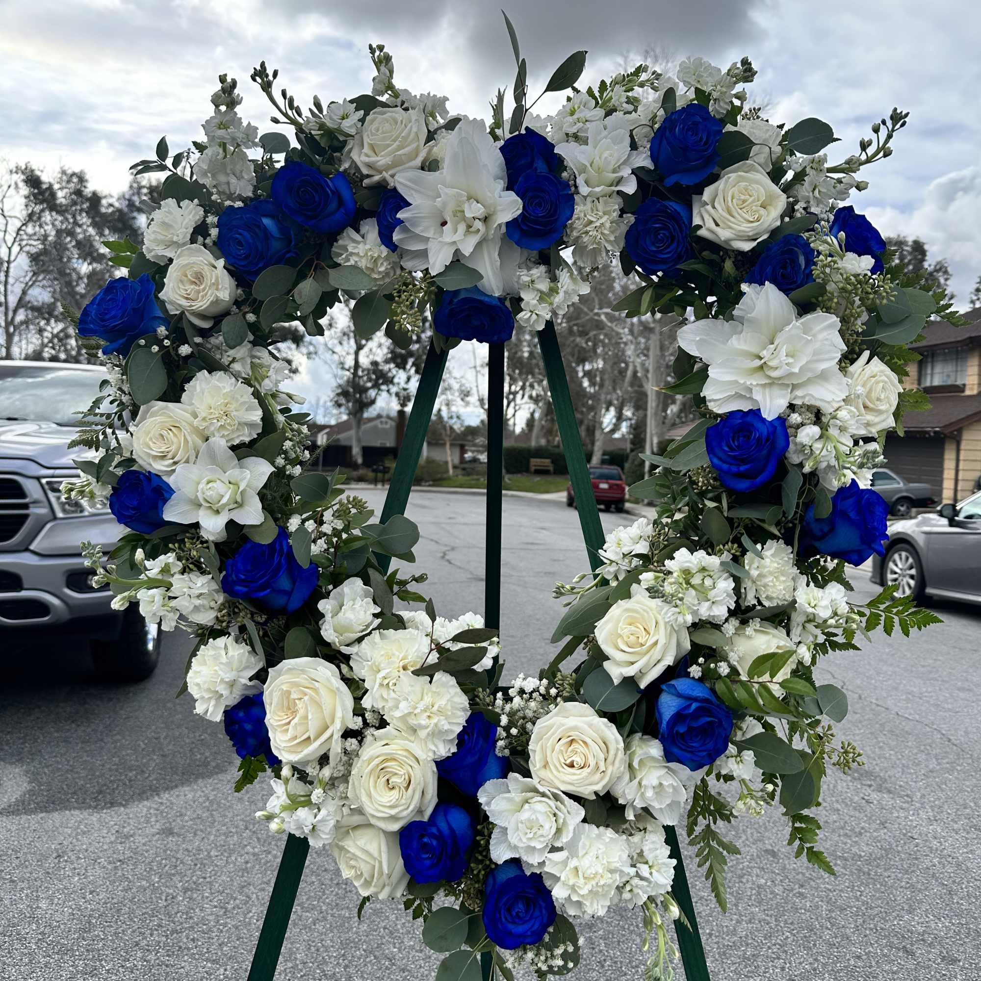 Blue and white floral wreath on a stand