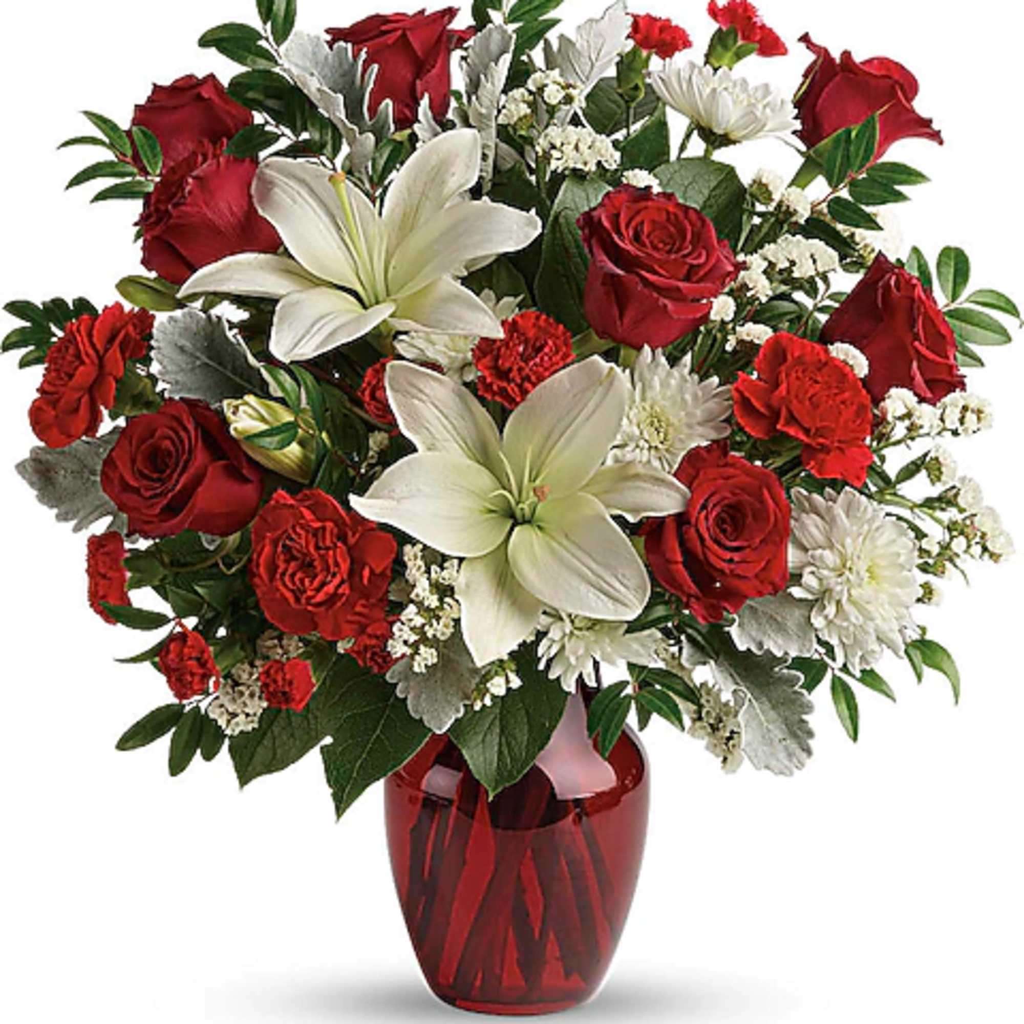 Red roses and white lilies arranged in a red glass vase