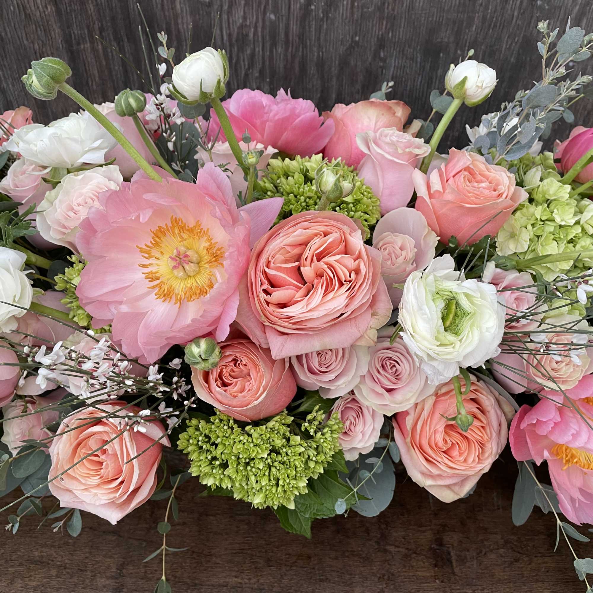 Pink and white floral arrangement with roses and peonies