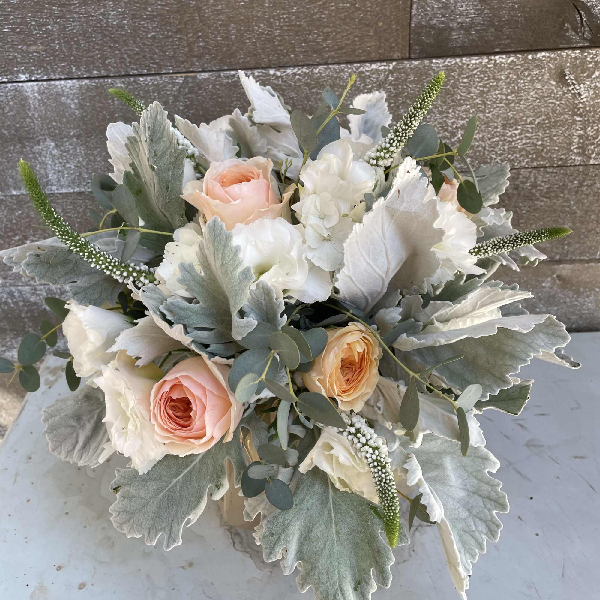 Bouquet of blush and white roses with silvery foliage
