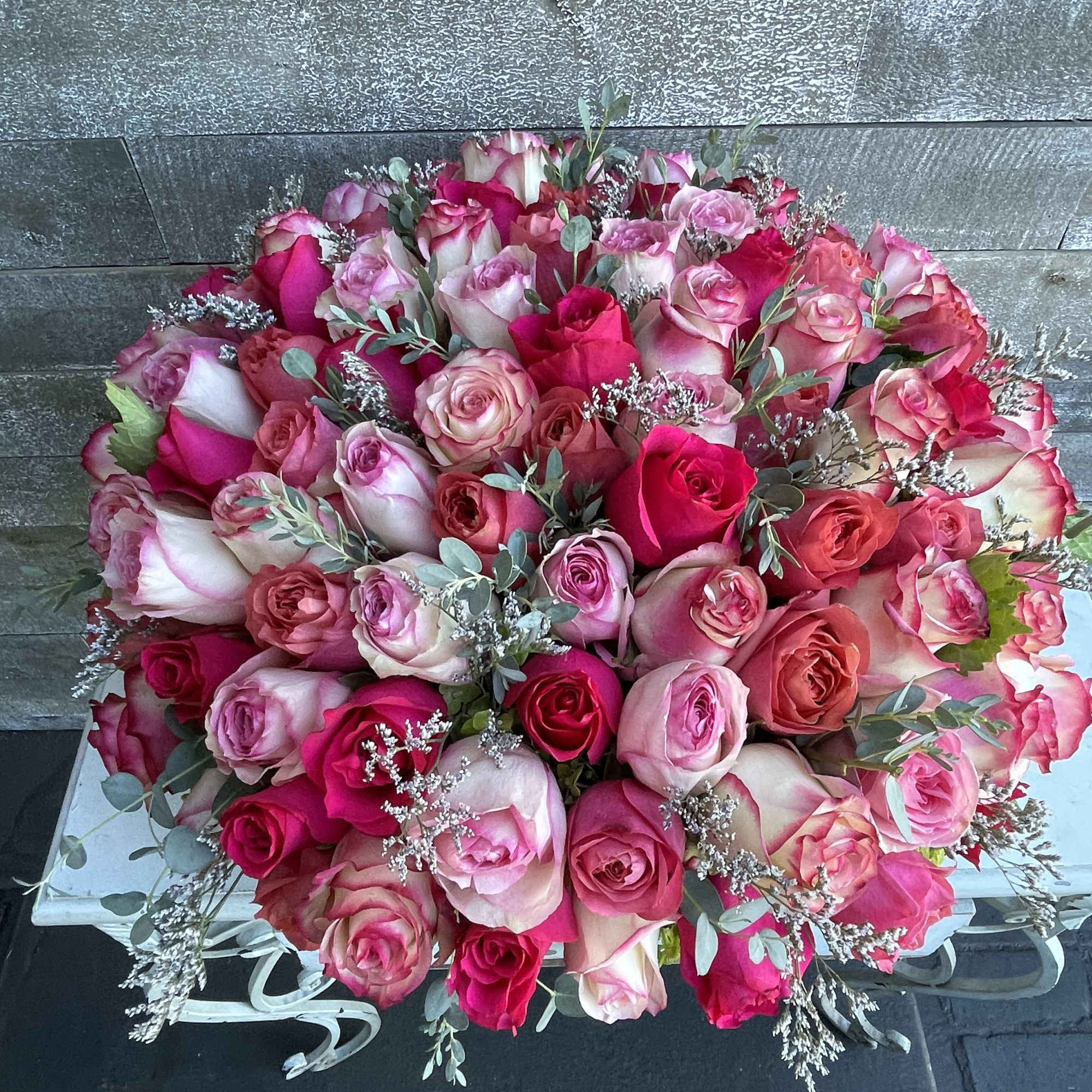 Large bouquet of pink and white roses with eucalyptus accents