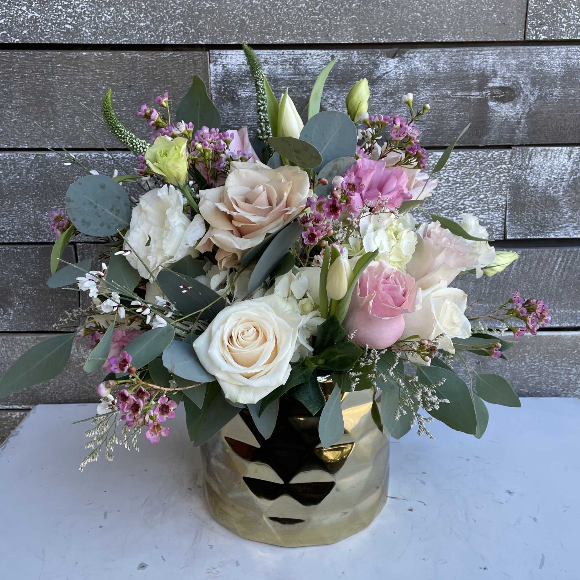 Mixed pink and white bouquet in a gold vase