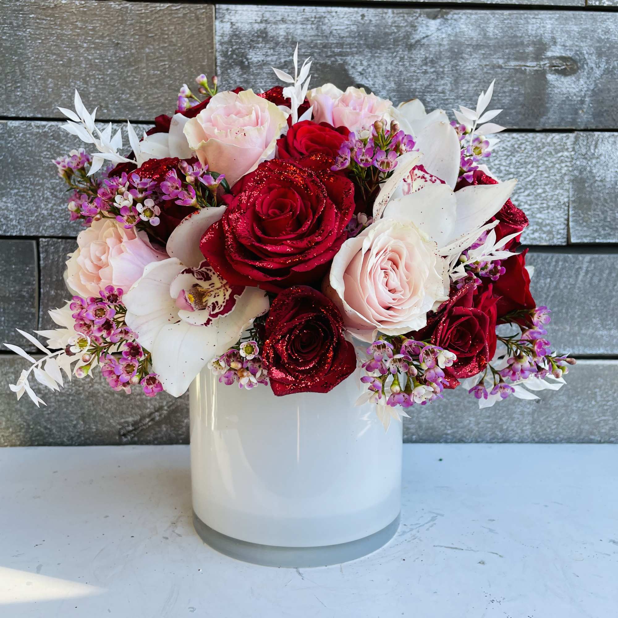 Red and blush roses arranged in a white vase, photo 2 of 2