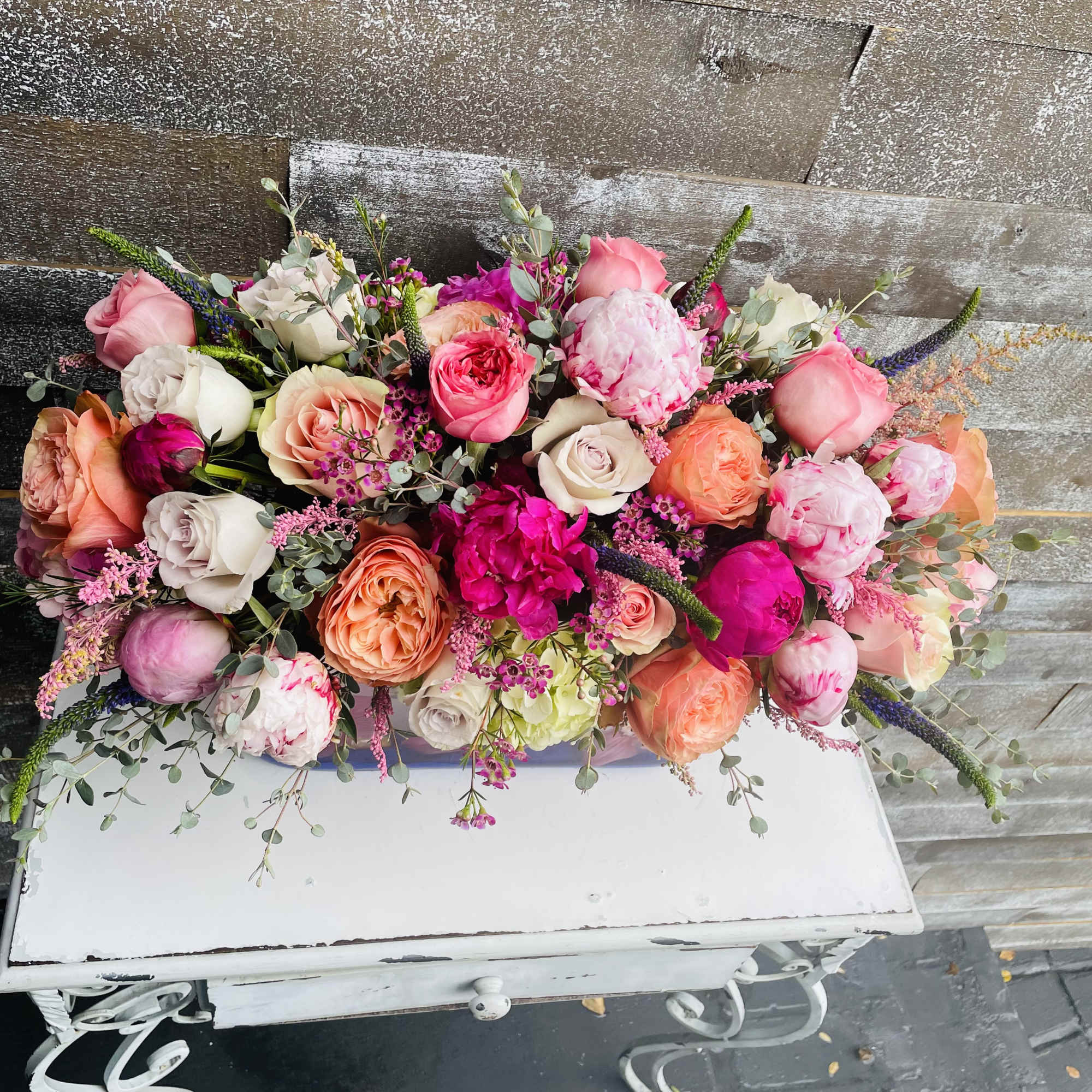Colorful bouquet of roses and peonies with airy filler flowers