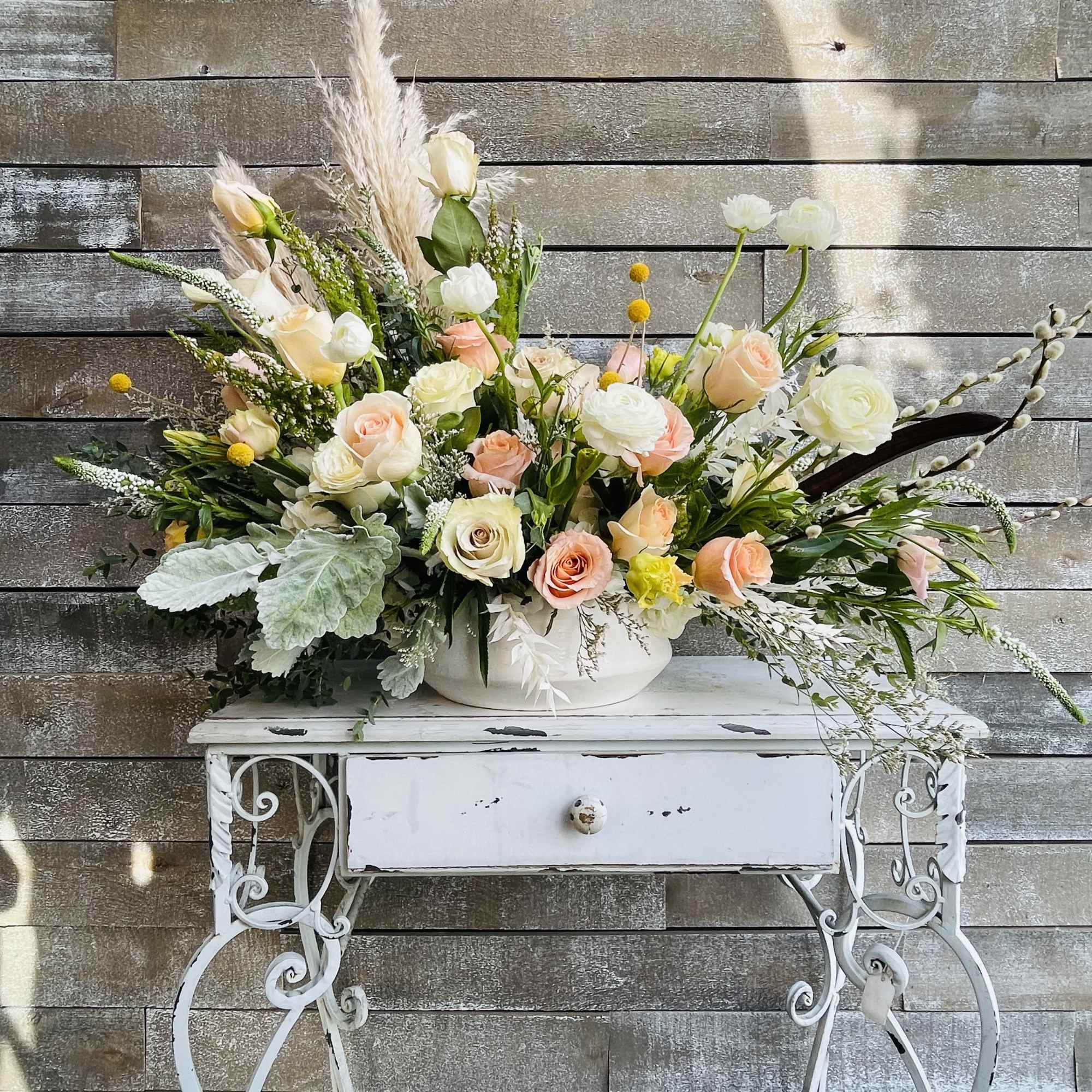 Large pastel floral arrangement in a white bowl on a decorative table, photo 2 of 6