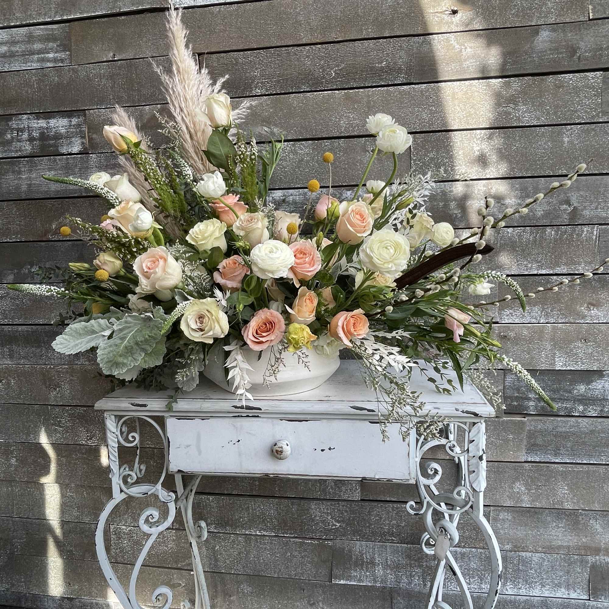 Large pastel floral arrangement in a white bowl on a decorative table, photo 5 of 6
