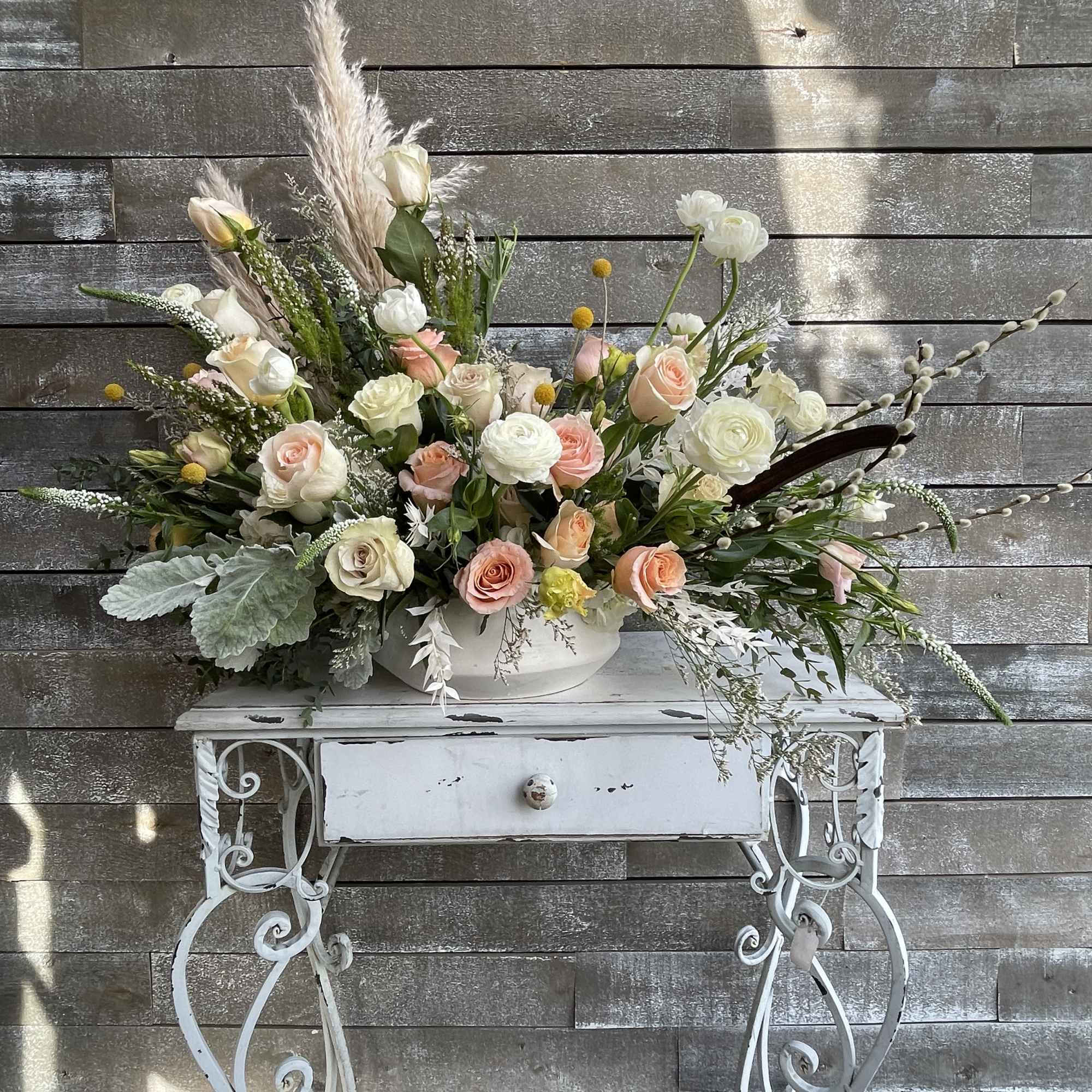 Large pastel floral arrangement in a white bowl on a decorative table, photo 6 of 6
