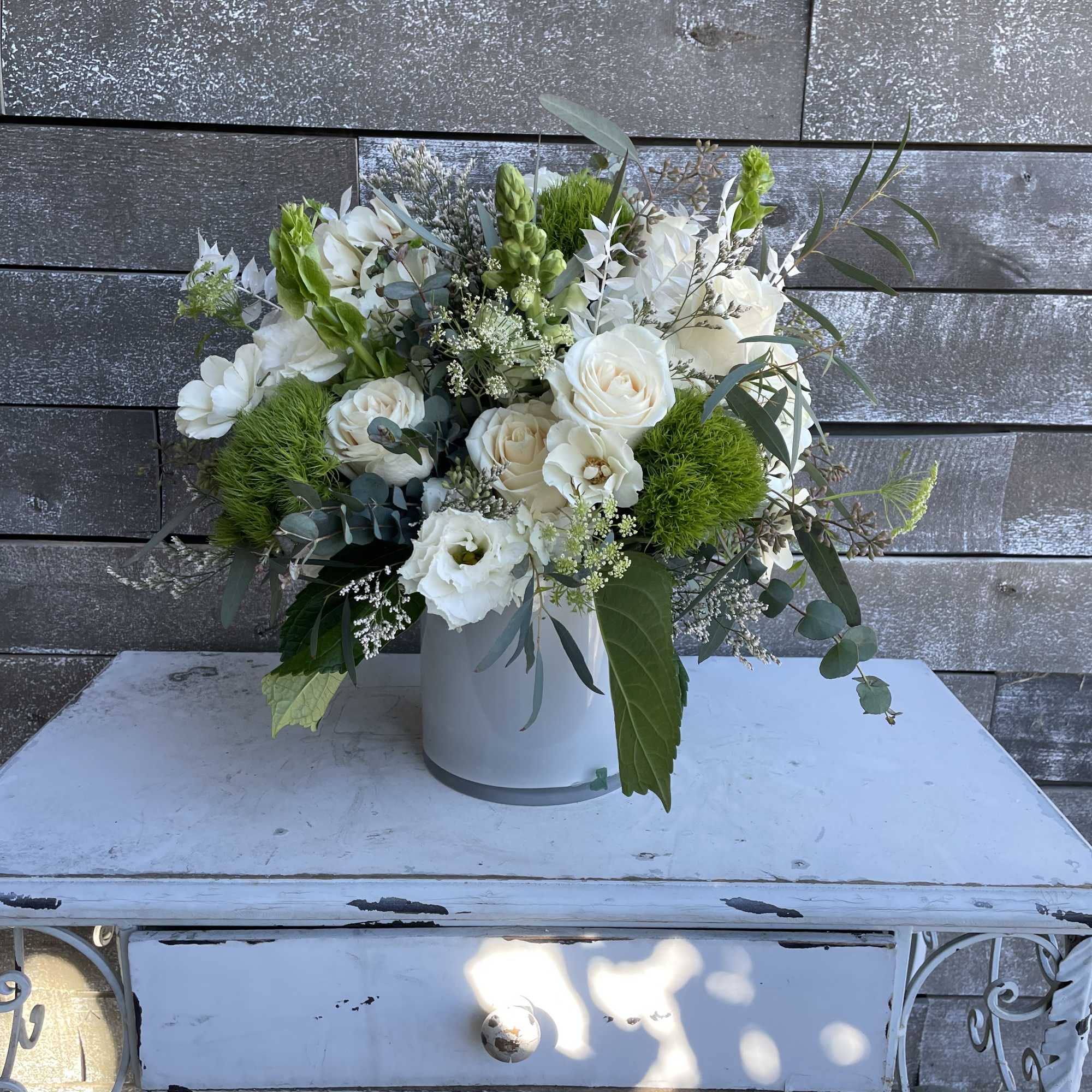 White floral arrangement in a pale vase with green accents, photo 5 of 5