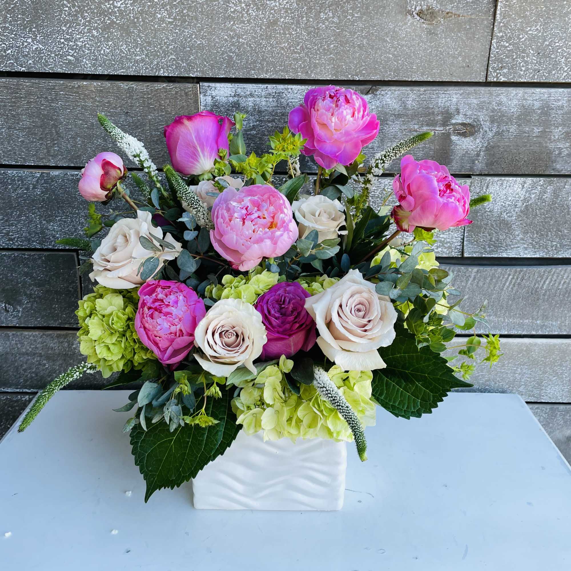 Pink peonies and roses arranged in a white vase, photo 4 of 4