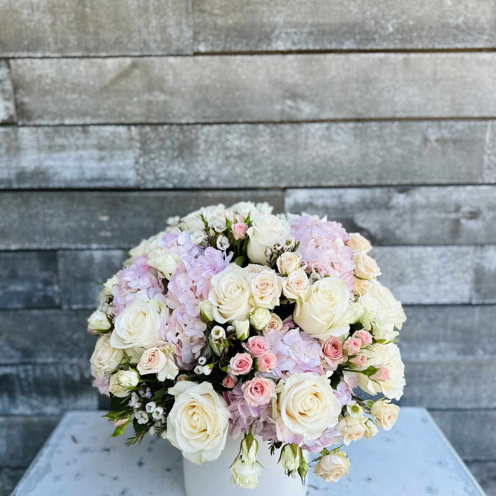 Blush whites and gorgeous blossoms or roses and hydrangea and a chic