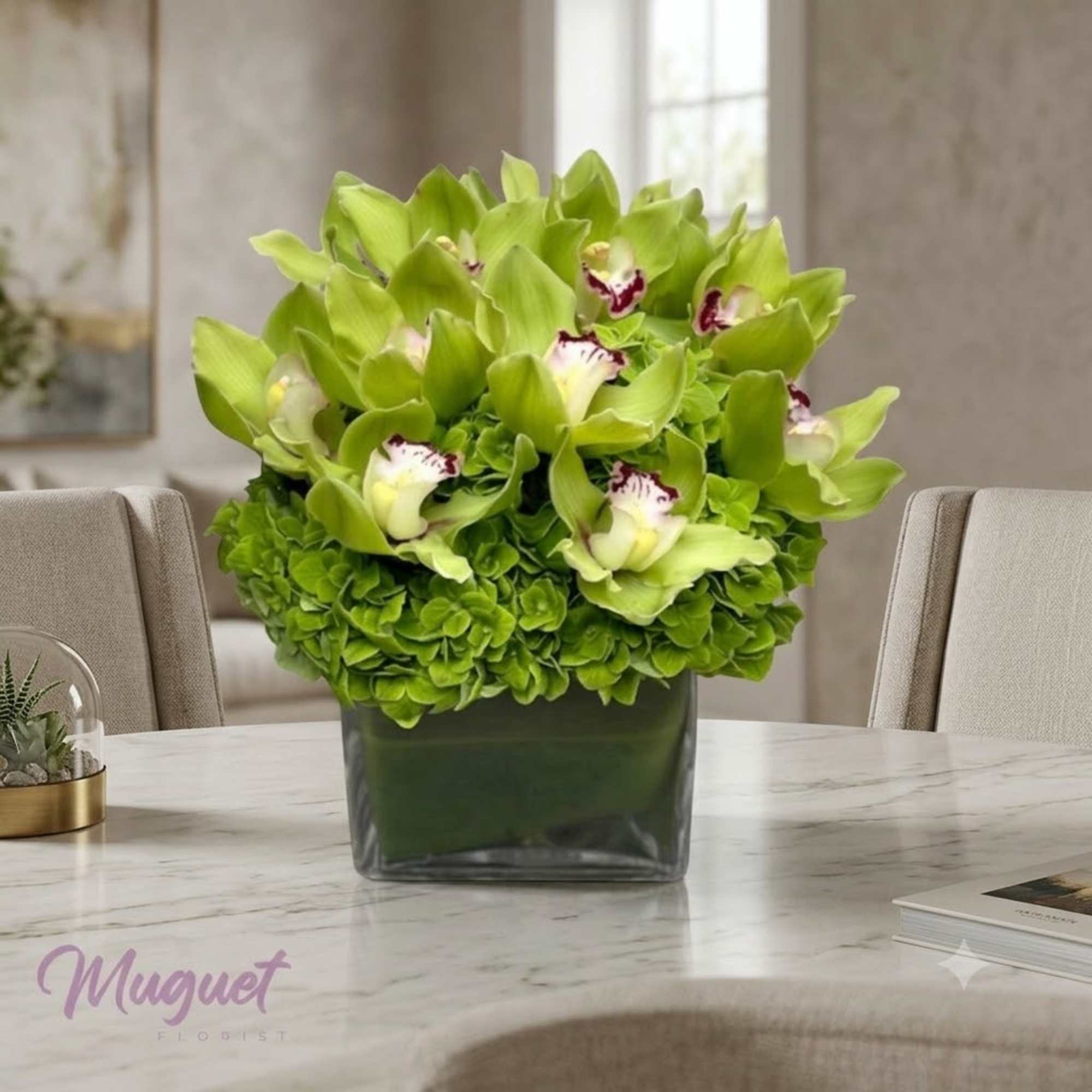 Green orchid and hydrangea arrangement in a square glass vase