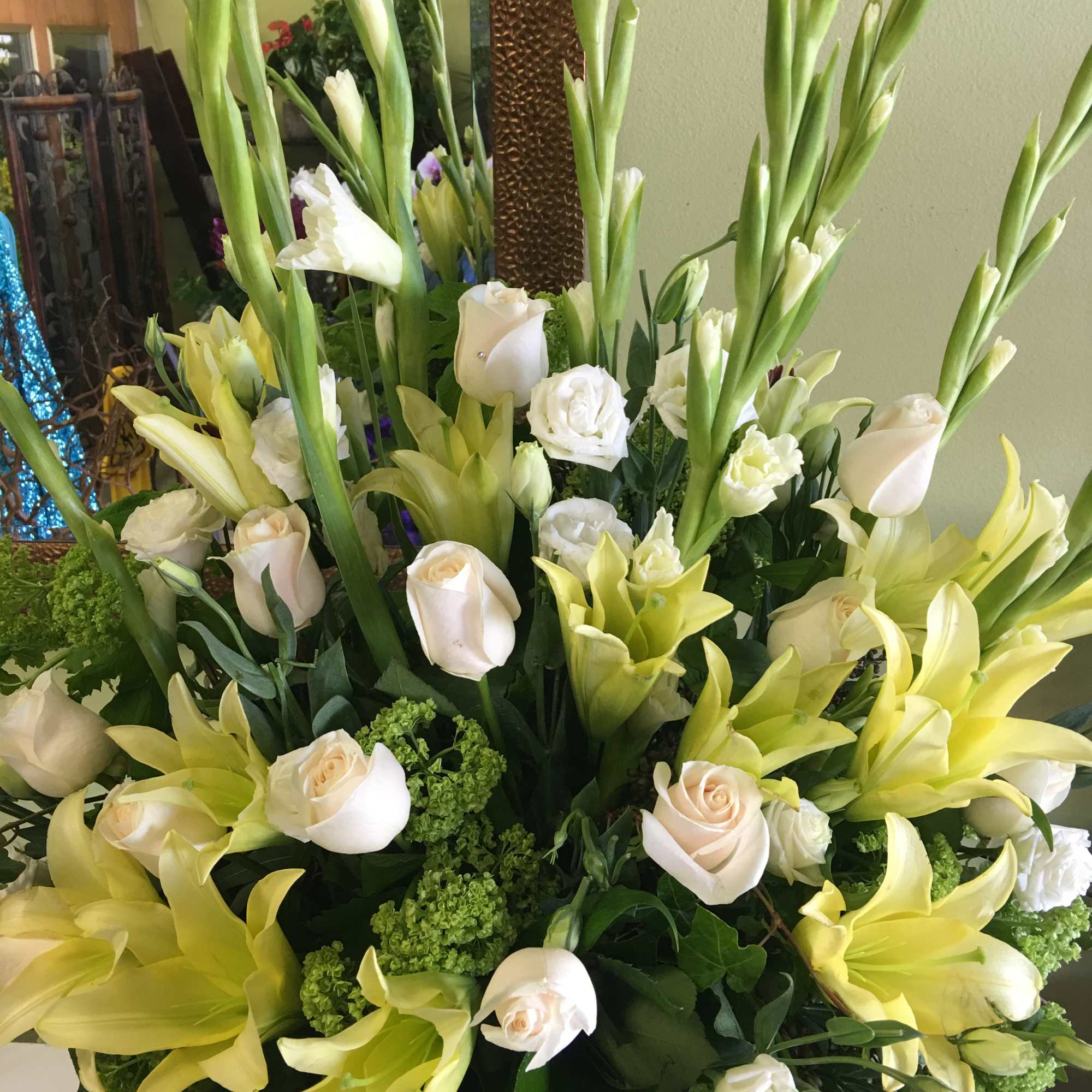 Tall bouquet of pale yellow lilies and cream roses