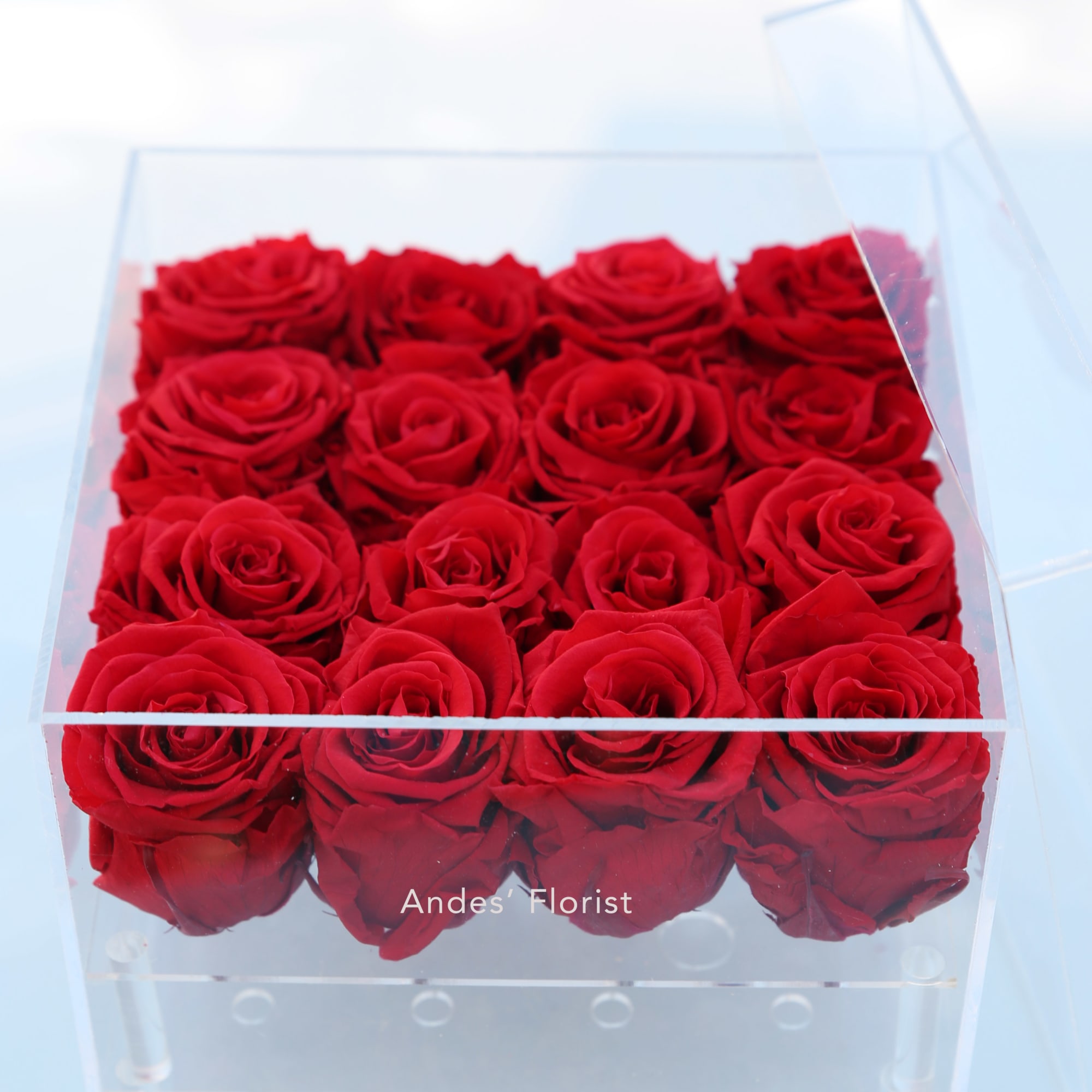 Box of red roses in a clear acrylic container